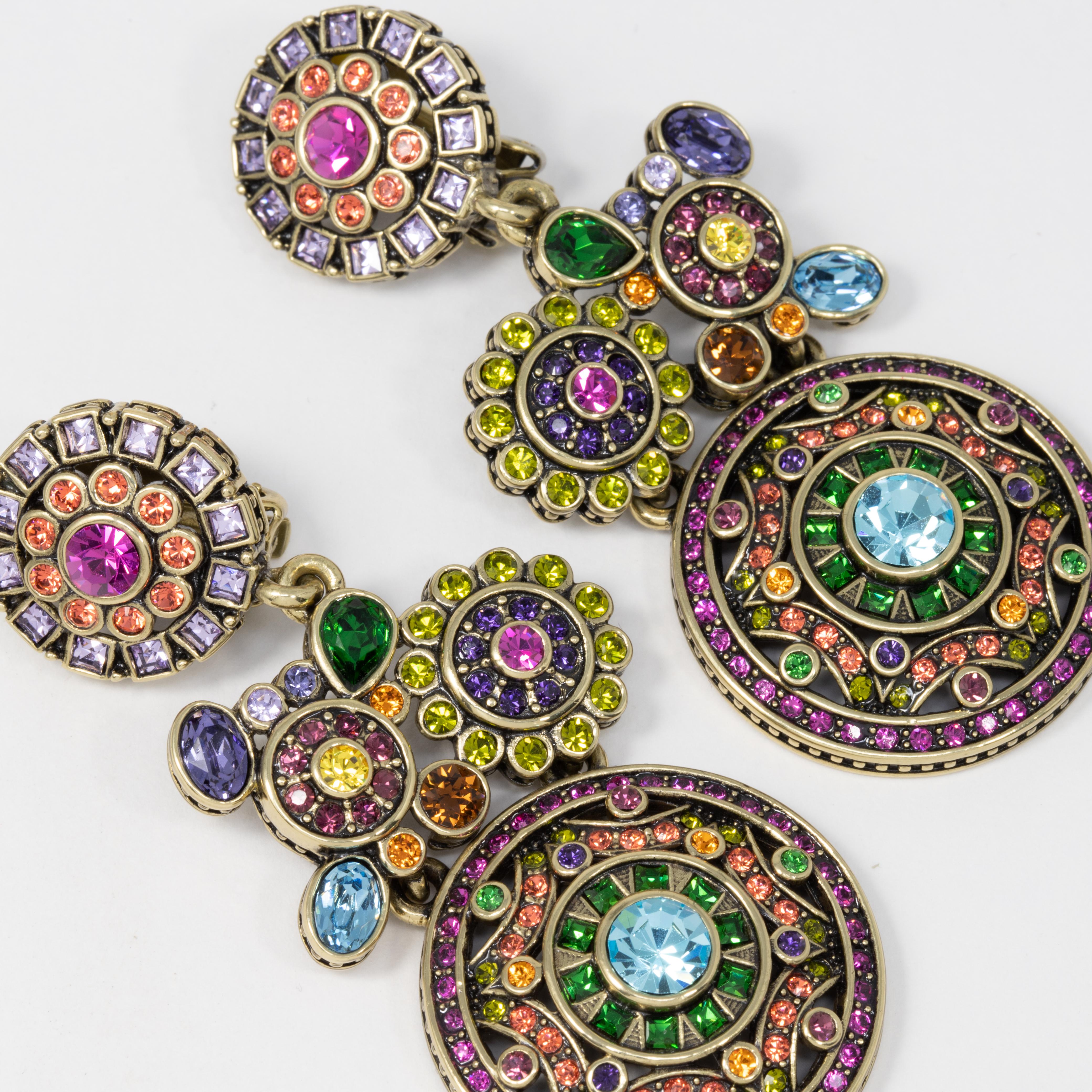 Heidi Daus ornate dangling clip on earrings. Each features large round flower and abstract motifs adorned with colorful crystals.

Hallmarks: Heidi Daus, China

