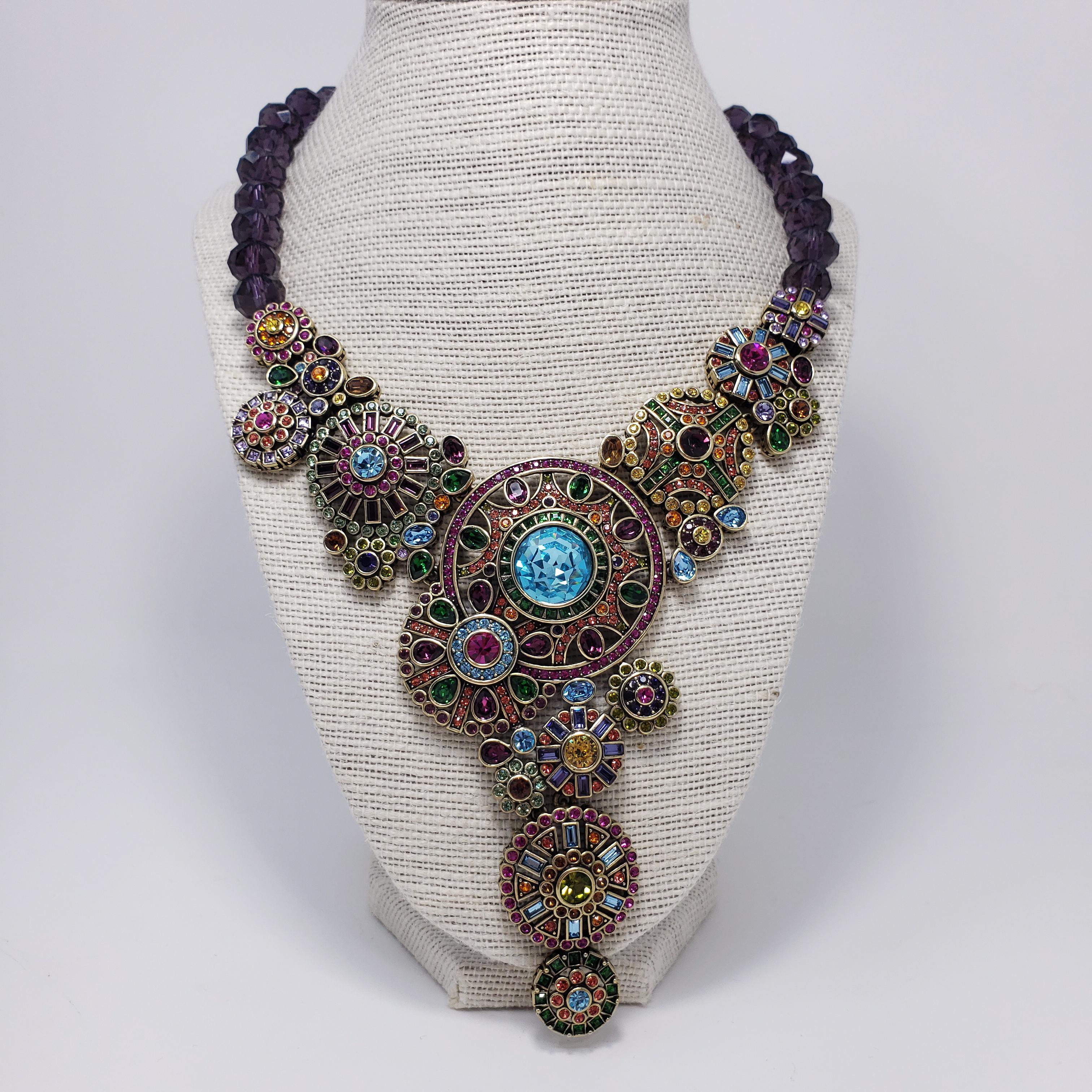 Heidi Daus ornate pendant necklace. Features large round flower and abstract motifs adorned with colorful crystals. Amethyst crystal necklace.

Hallmarks: Heidi Daus, China

Pendant Dimensions: 7.5 cm / 3 in by 7.5 cm / 3 in
Necklace Length 40 cm /
