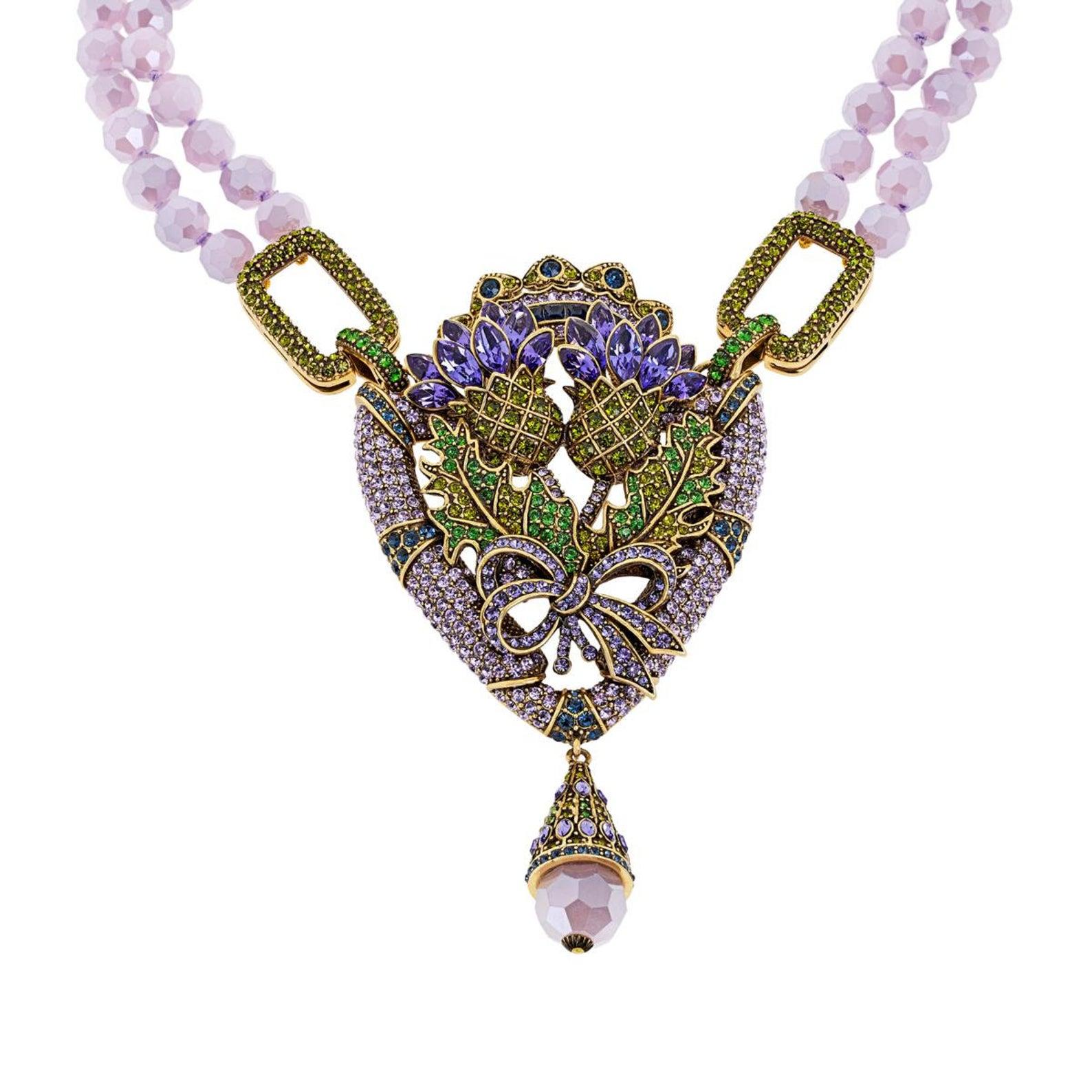 Flowers wilt, but jewelry lasts forever. Express your love of all things beautiful with this sparkling crystal-adorned wearable art piece from Heidi Daus.

Design Information
2 strands of individually knotted, faceted violet opal-colored glass