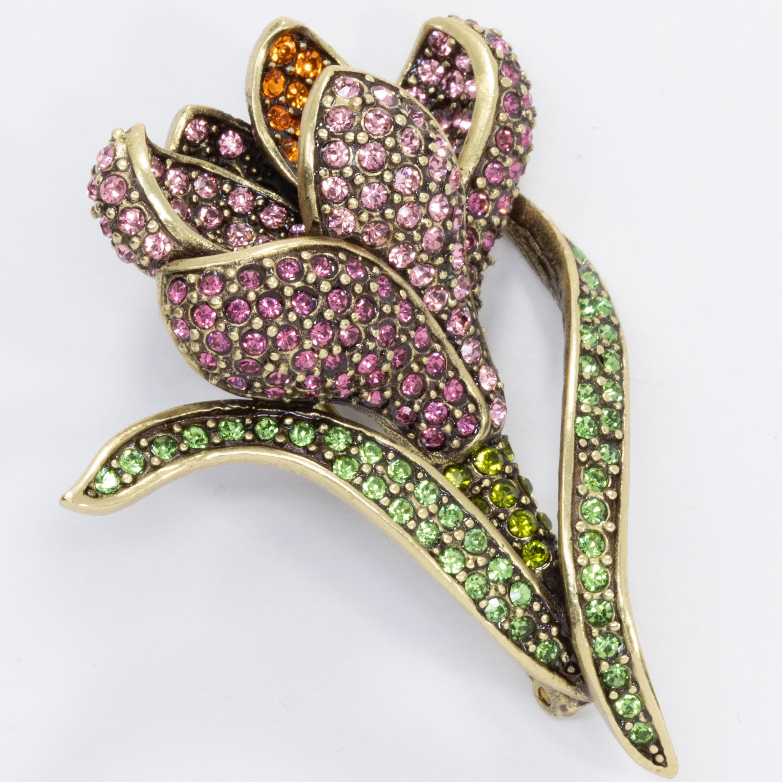 Add an elegant floral touch to your style with this flower brooch from Heidi Daus. Accented with pave rose, peridot, and tangerine crystals, this gorgeous flower pin sparkles like no other!

Limited-time, retired collection.

Hallmarks: Heidi Daus,
