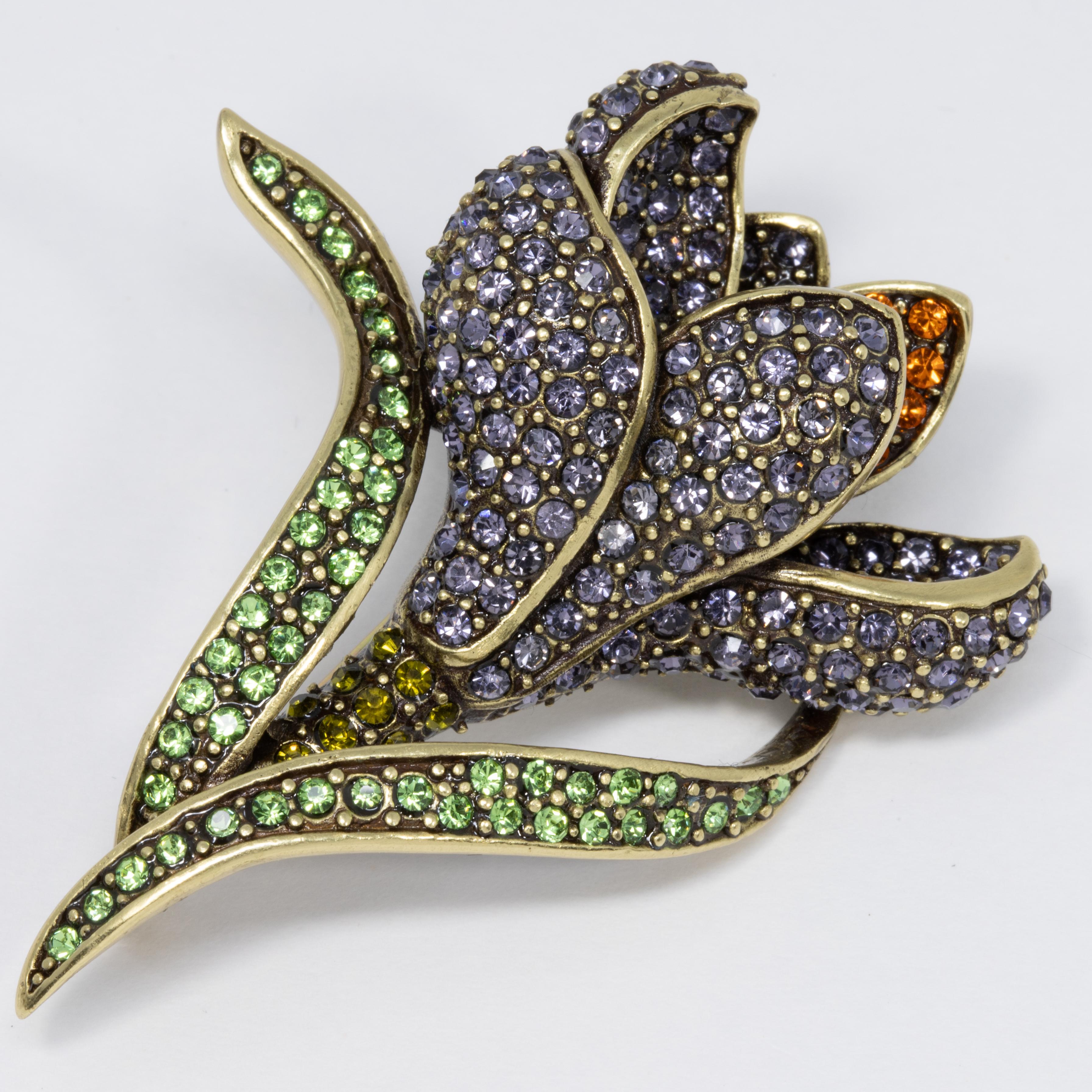 Add an elegant floral touch to your style with this flower brooch from Heidi Daus. Accented with pave lilac, peridot, and tangerine crystals, this gorgeous flower pin sparkles like no other!

Limited-time, retired collection.

Hallmarks: Heidi Daus,