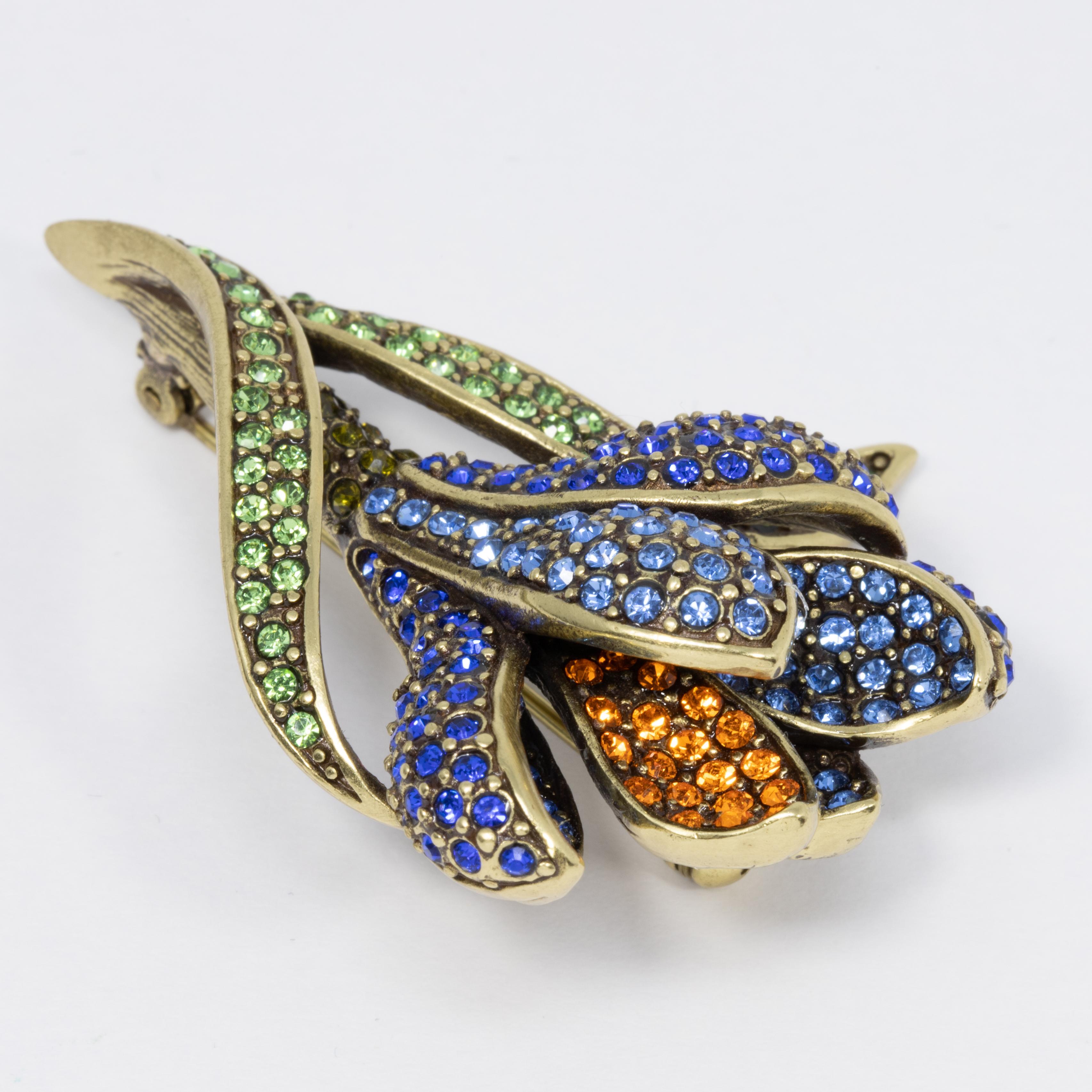 Add an elegant floral touch to your style with this flower brooch from Heidi Daus. Accented with pave aquamarine, cobalt, peridot, and tangerine crystals, this gorgeous flower pin sparkles like no other!

Limited-time, retired