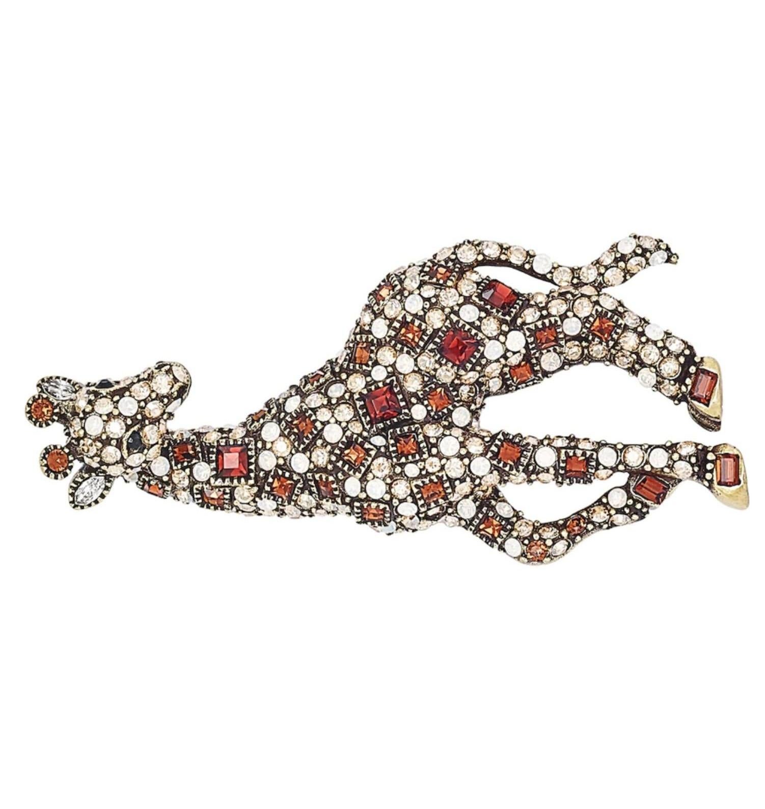 Let this sassy and stylish Georgette Giraffe Crystal Critter Pin by Heidi Daus saunter into your jewelry wardrobe.

• Brass with bronze tone plating
• Various amounts, shapes and sizes of cognac clear and opaque AB crystals, faceted

• Pin