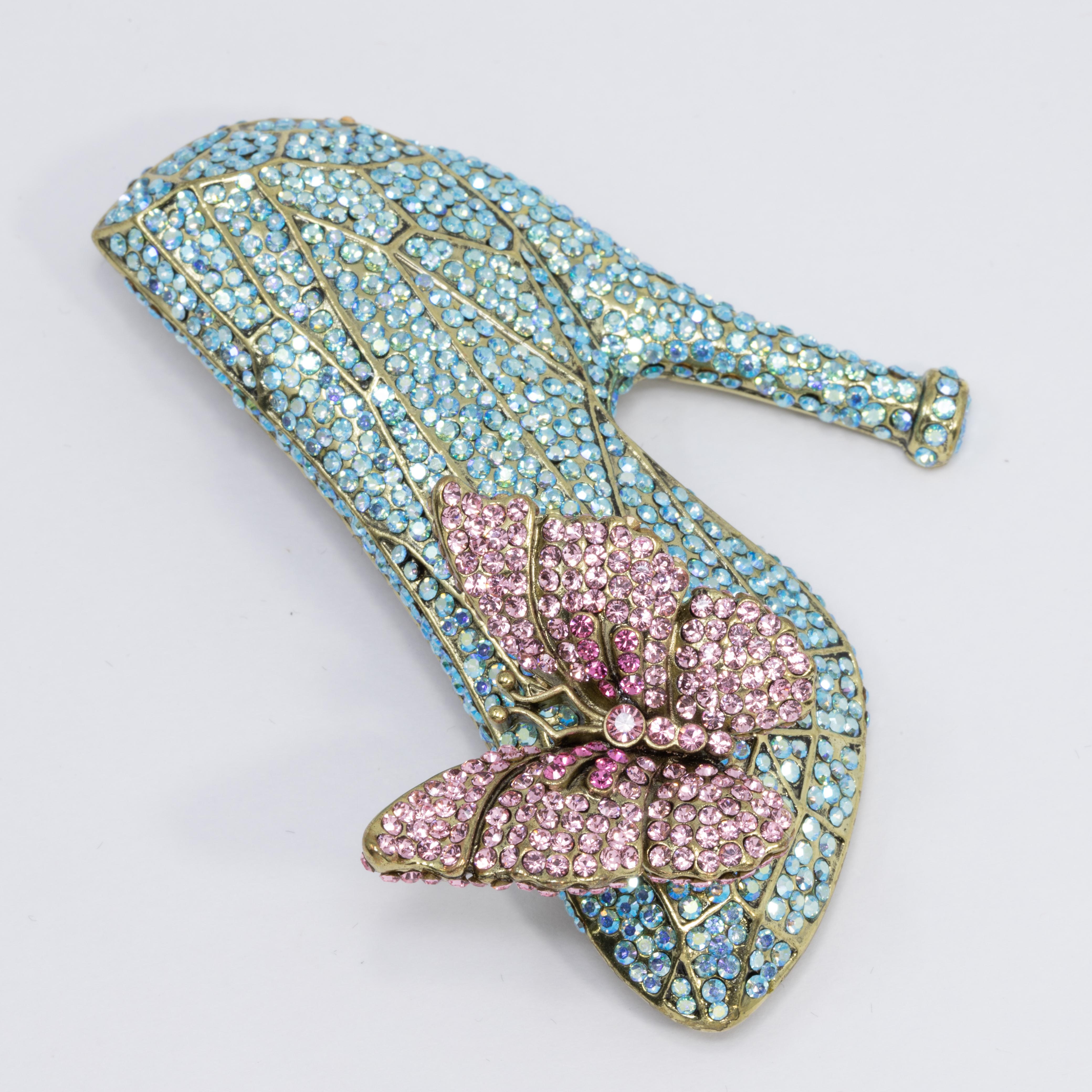 Cinderella-inspired glass slipper pin brooch from Heidi Daus. Features a pave crystal shoe and butterfly. Perfect for your own happily ever after!

Limited-time, retired collection.

Hallmarks: Heidi Daus, CN