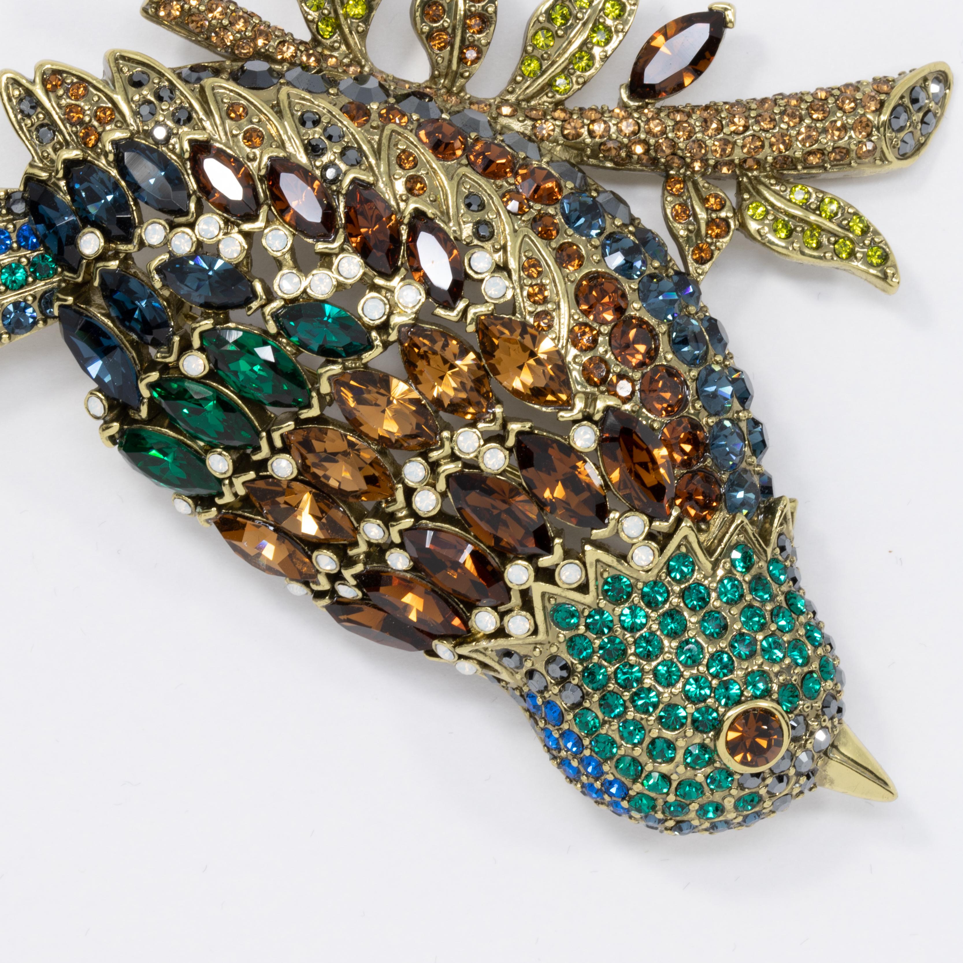 Take fashionable flight with this sparkling bird perched on a jewel-encrusted branch. Pin brooch by Heidi Daus.

Amber, emerald, smoky topaz, and olive crystals

Limited-time, retired collection.

Hallmarks: Heidi Daus, CN