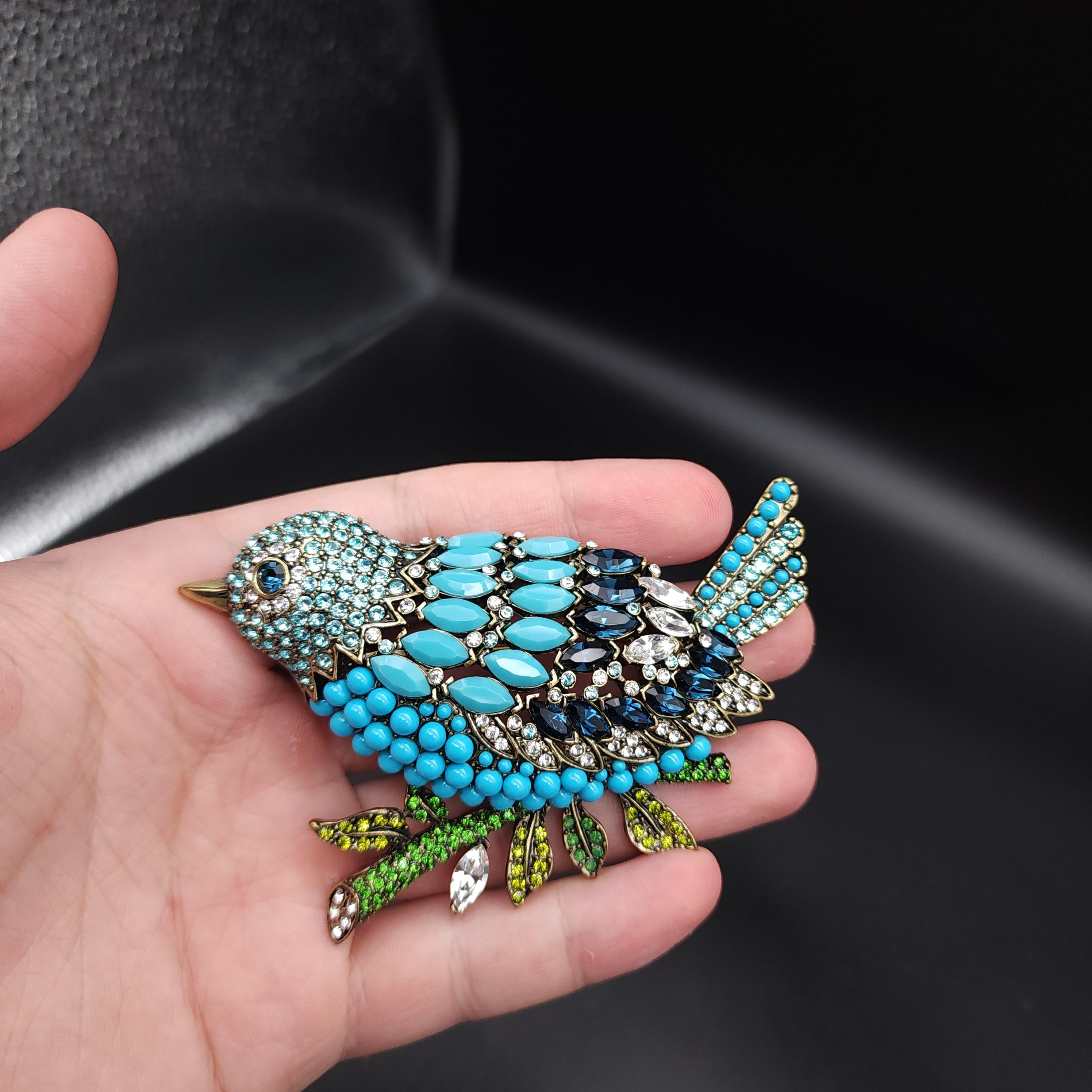 Take fashionable flight with this glamorous bird, adorned with turquoise crystals & cabochons, and perched on a jewel-encrusted branch with olivine, peridot, and jade colored crystals. 

Antique Brass Tone

Pin brooch by Heidi Daus.

Limited-time,