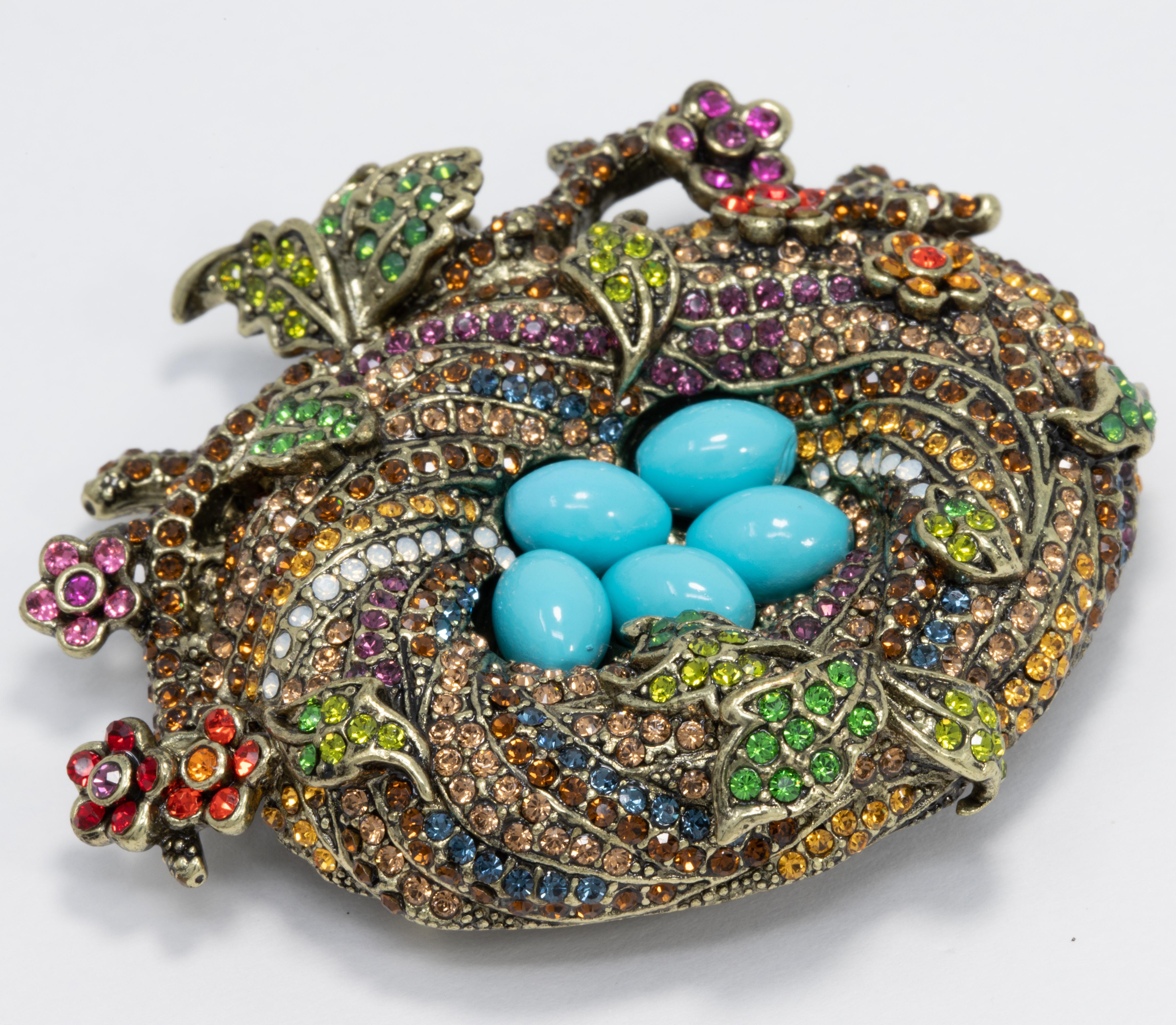 You never have an empty nest, even when you're on your own. Celebrate life, love and family with this beautiful sparkling crystal bird's nest pin from Heidi Daus.

Colorful crystals and faux turquoise cabochons on an exquisite brass-tone