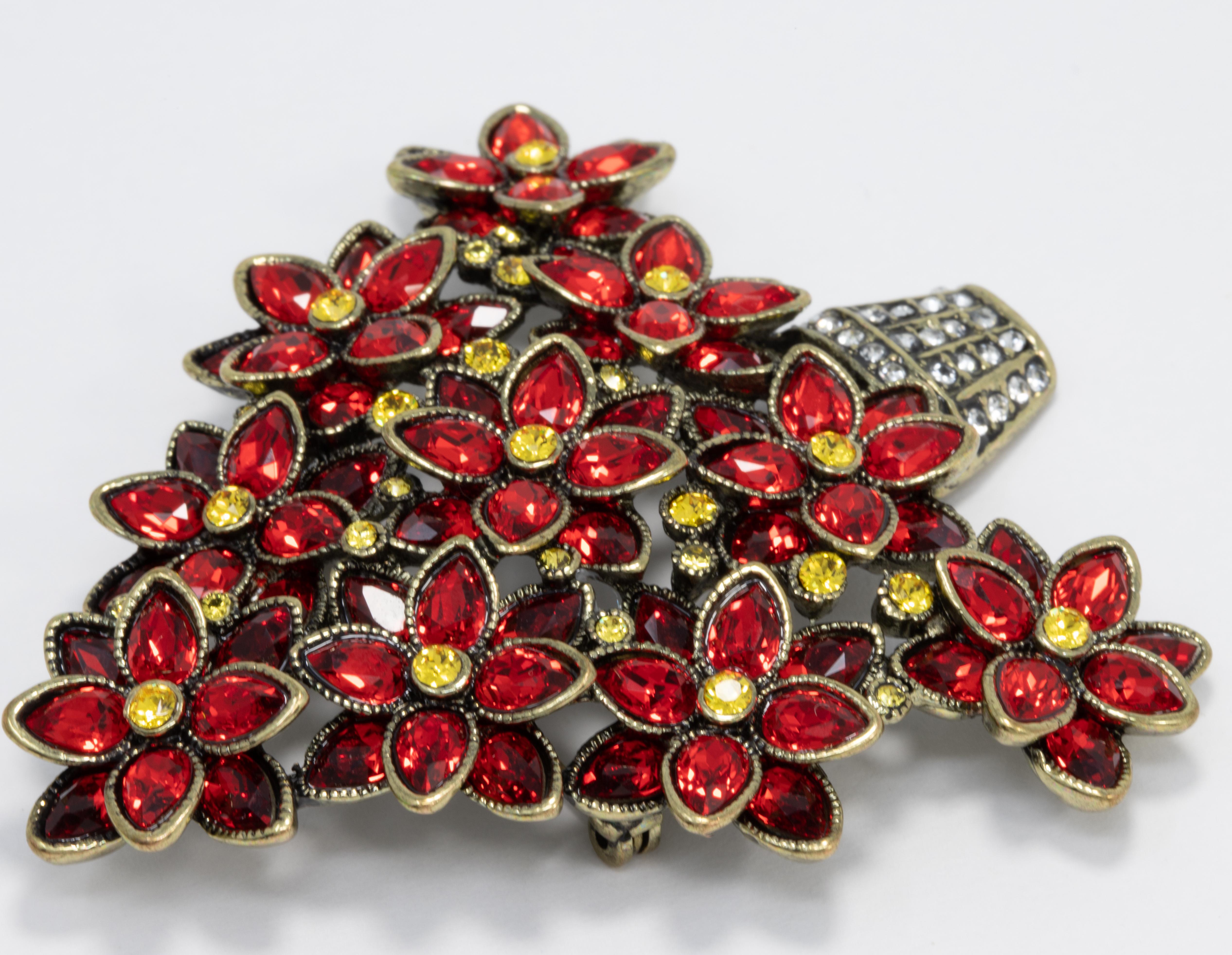 A pretty poinsettia plant decorated with siam and lemon topaz crystals by Heidi Daus. 

Exquisite brass-tone brooch setting.

Marks / hallmarks: Heidi Daus, China