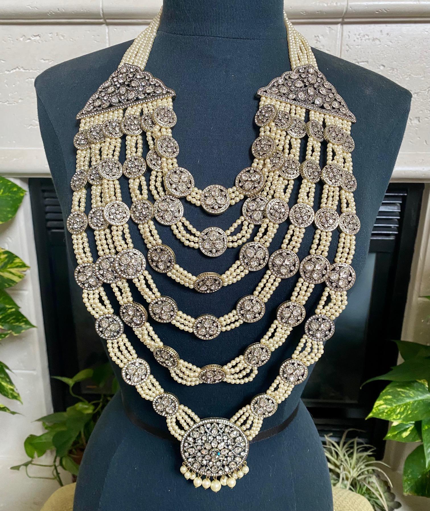 Showstopper Statement 5 Strand Necklace, a piece of art. Great for Weddings, Actors & Special Events

WOW! Release your inner goddess with this breathtaking India inspired drop bib statement necklace.
5 strands 6 mm white glass pearls are linked