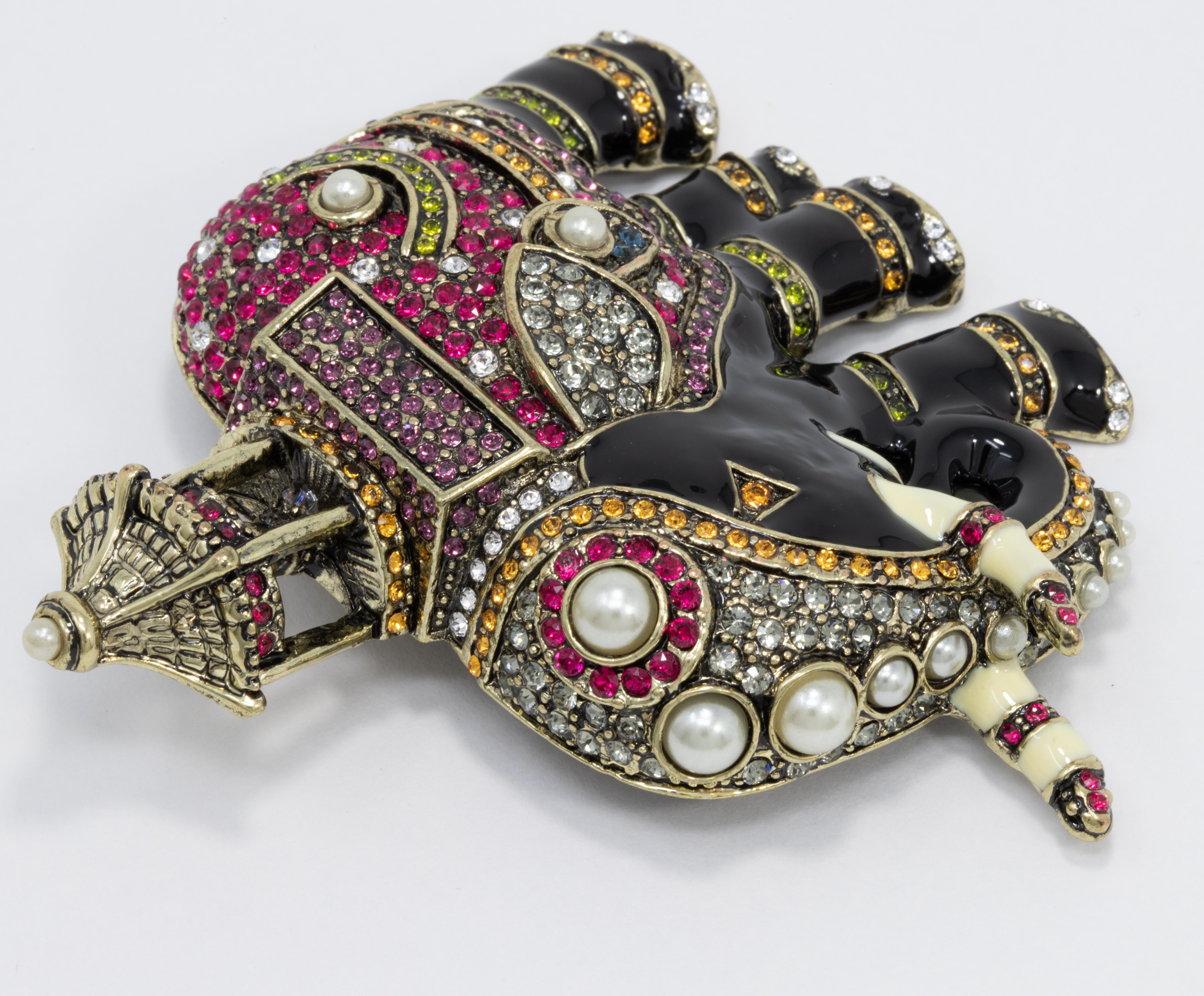 An exotic Heidi Daus pin brooch! A jeweled, enameled, elephant decorated with faux pearls and clear, tangerine, rose, and olivine crystals.

Marks / hallmarks / etc: Heidi Daus, China