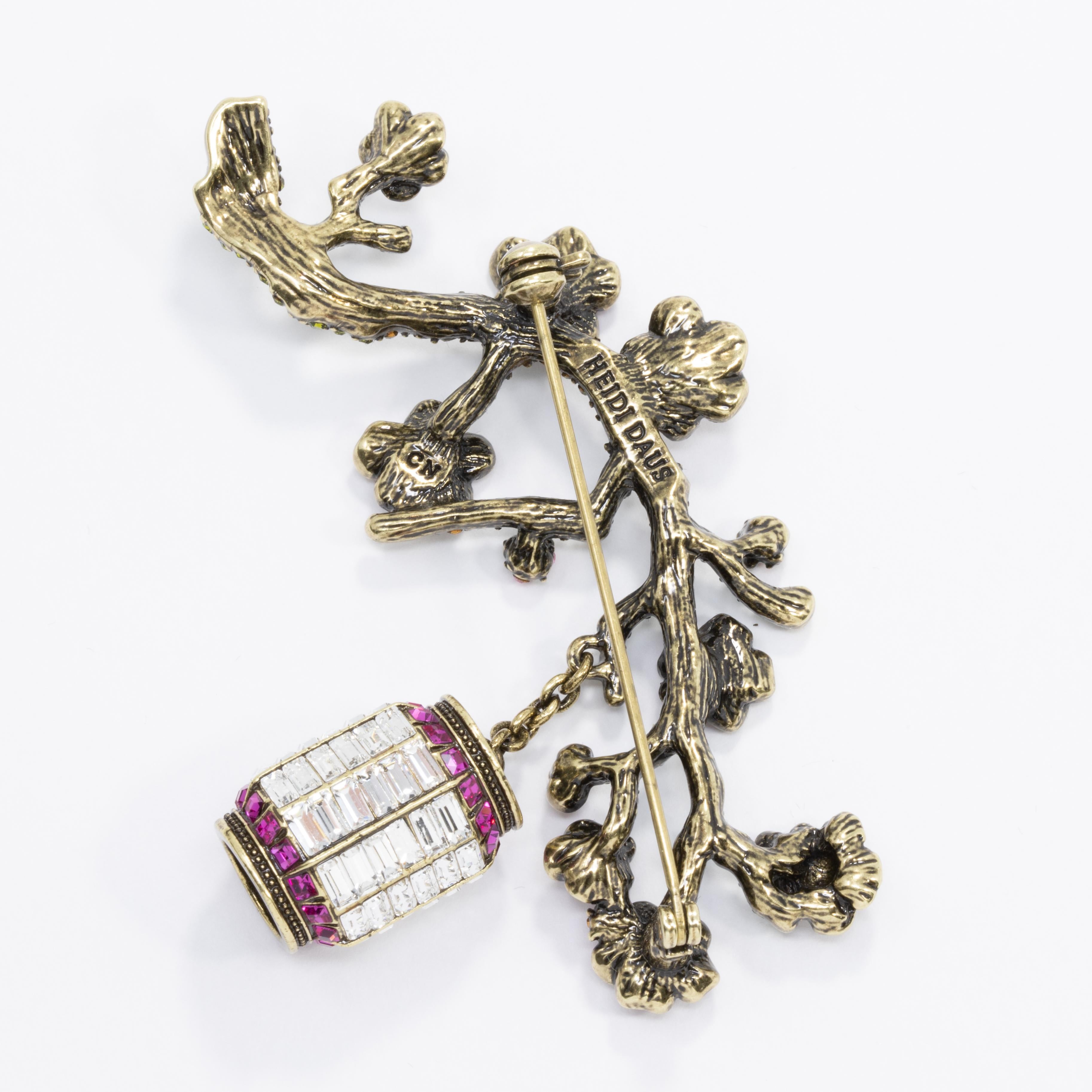 Light up your look with sparkling sakura style. Beautiful cherry blossoms dance in the light of a Japanese lantern, creating an exotic eastern look to add to your dazzling brooch collection.

Measurements: Approx. 2-1/4