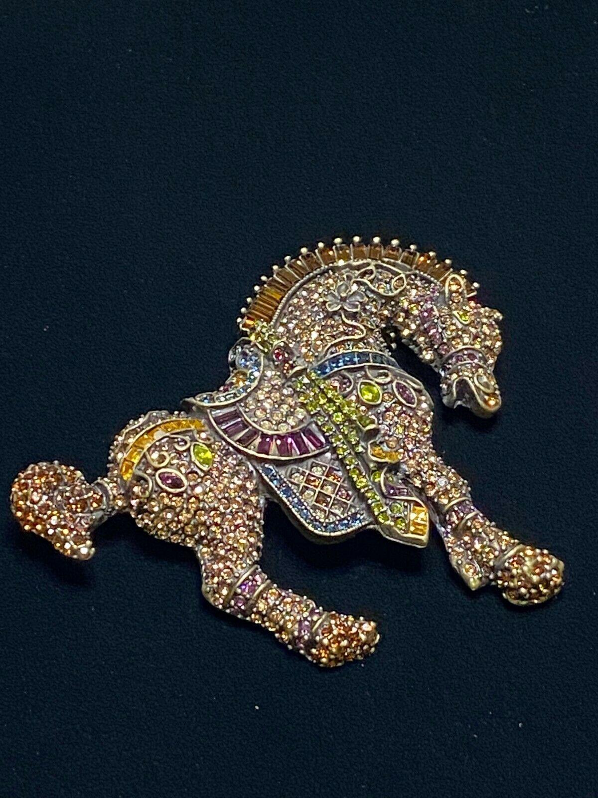 Chic and Dramatic Bowing Show Horse design Equestrian brooch encrusted with  pave-set sparkling multicolored crystals. Fancy saddle and decorative accents feature square, marquise and baguette crystals; mane composed of prong-set crystal baguettes.