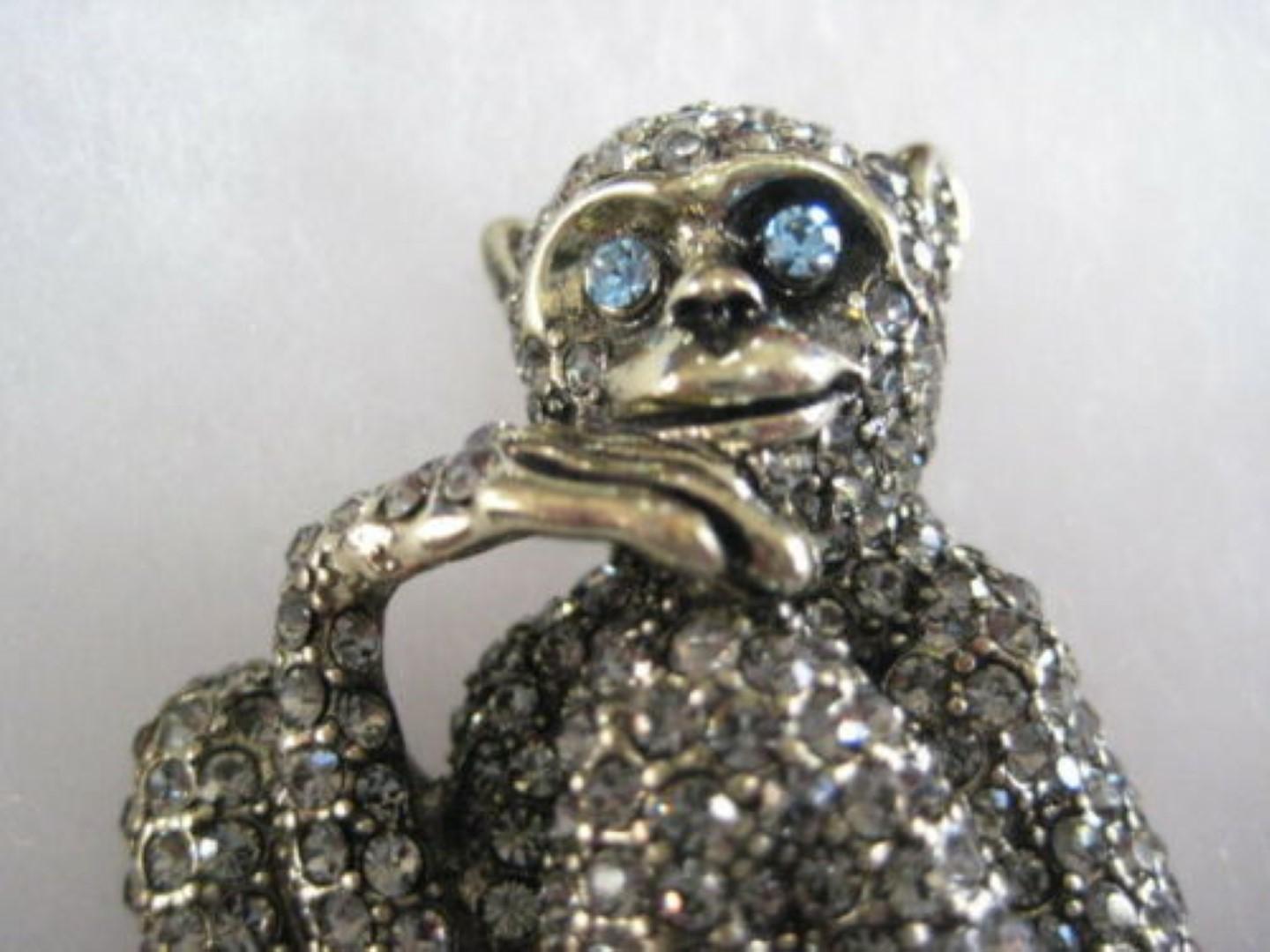 Chic and Whimsical Monkey design brooch encrusted with  pave-set sparkling crystals. Beautifully detailed as the Monkey sits in The Thinker pose and ponders about life atop his gorgeous Aquamarine crystal perch! Approx. size: 3.25