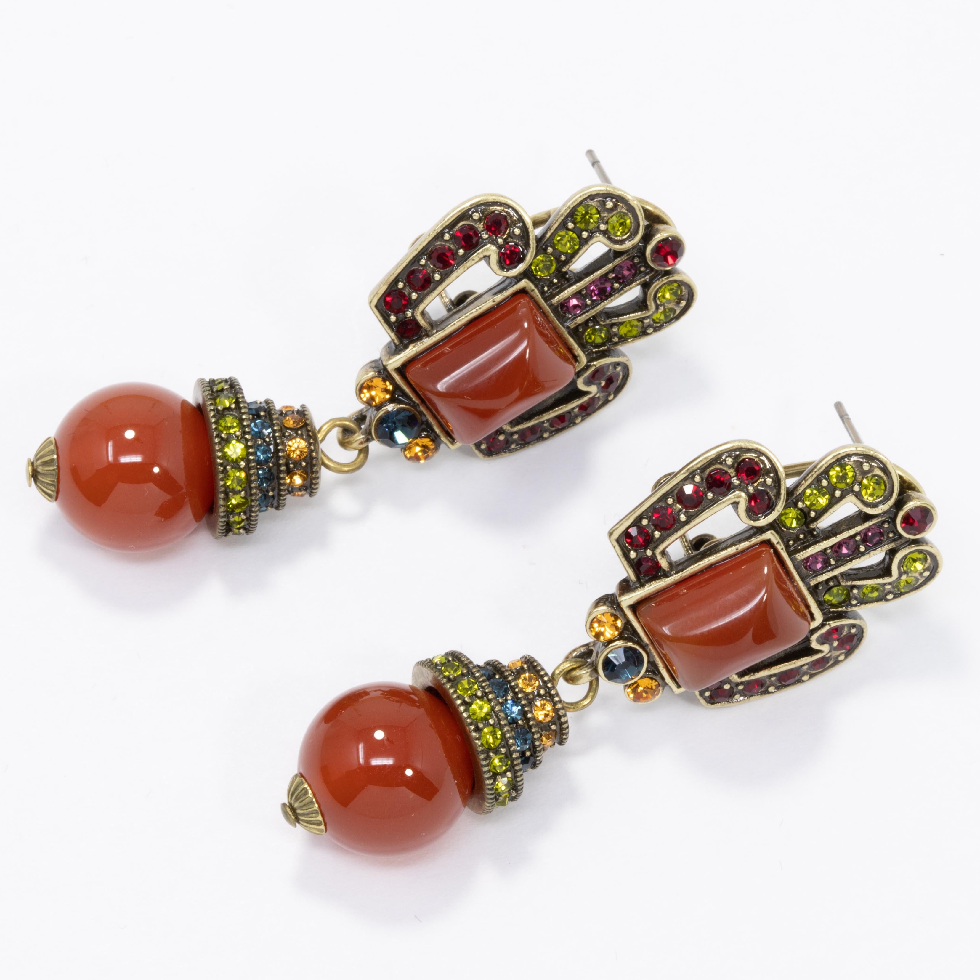Illuminate the room with your glamour! A pair of lantern clip on earrings decorated with sparkling crystal details, and amber cabochons.

Hallmarks: Heidi Daus, CN
