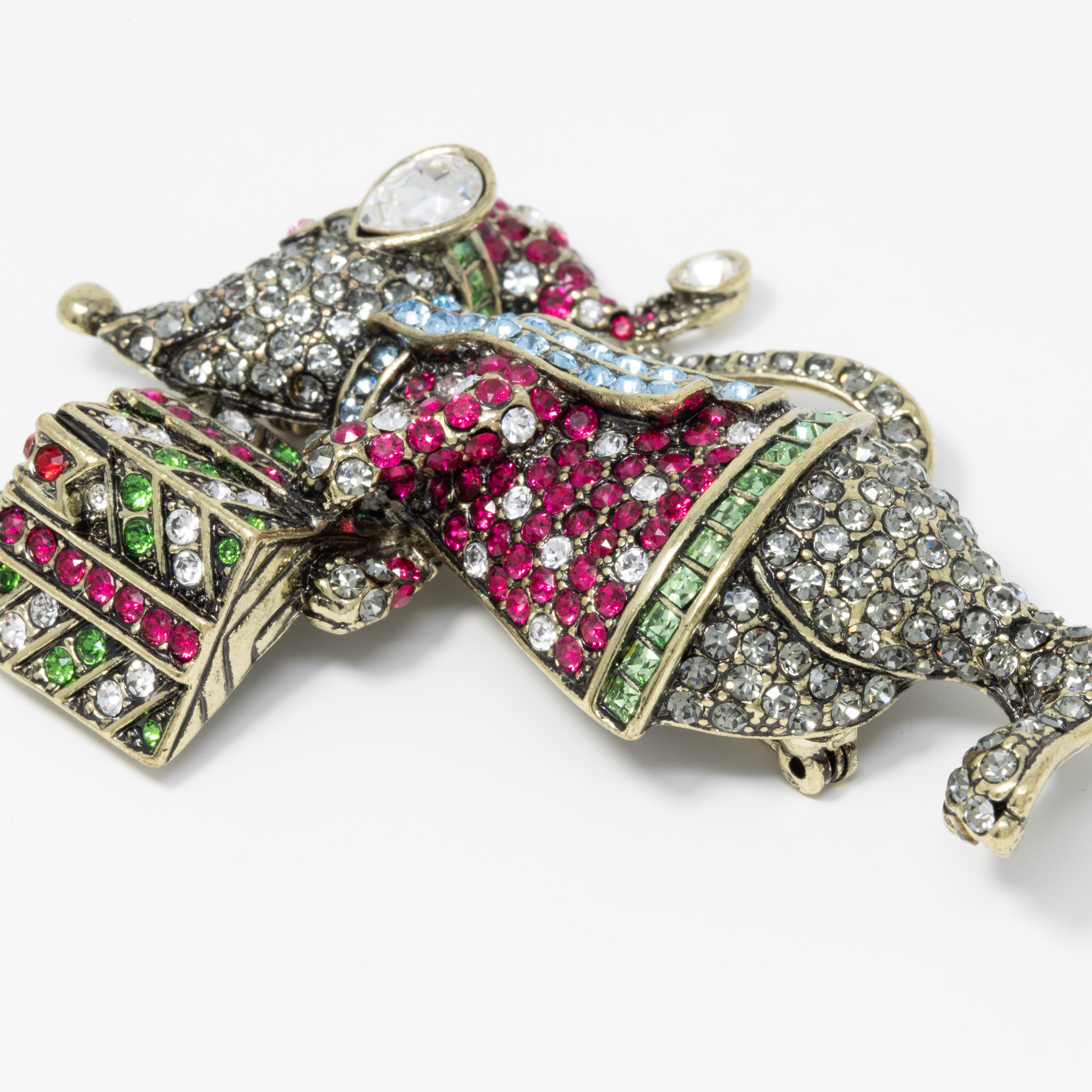 A festive mouse with a gift! This sparkling pin brooch features a crystal-encrusted mouse ready for for the holidays. Pin brooch by Heidi Daus.

Crystals :clear, rose, Siam, ruby, aquamarine, dark moss green, fern green and black diamond

Hallmarks: