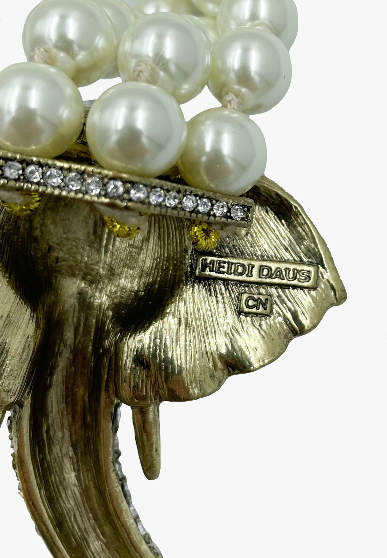 Gorgeous Heidi Daus faux pearl necklace embellished with an elephant head in strass . 

Signed. 

The length of the necklace is adjustable. You can wrap a string of pearls around the elephant as per your preference.

The total length of the necklace