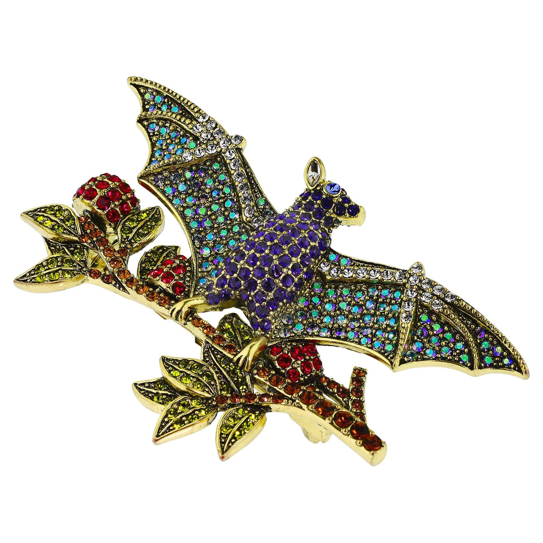 Is perfect for wearing to any Halloween festivities, and for pairing with all your fall favorites. A bejeweled bat sits atop a dazzlingly detailed tree branch composed of pave encrusted leaves, with red crystal pavé and bronze metal accents. Pair