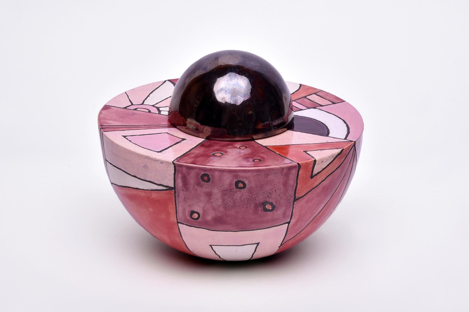This ceramic vase-like urn with a little golden ball on top is a unique piece handcrafted with care and passion. This beautiful memorial artwork combines aesthetic beauty with deep symbolic meaning. It is an expression of eternity and memory. Honor