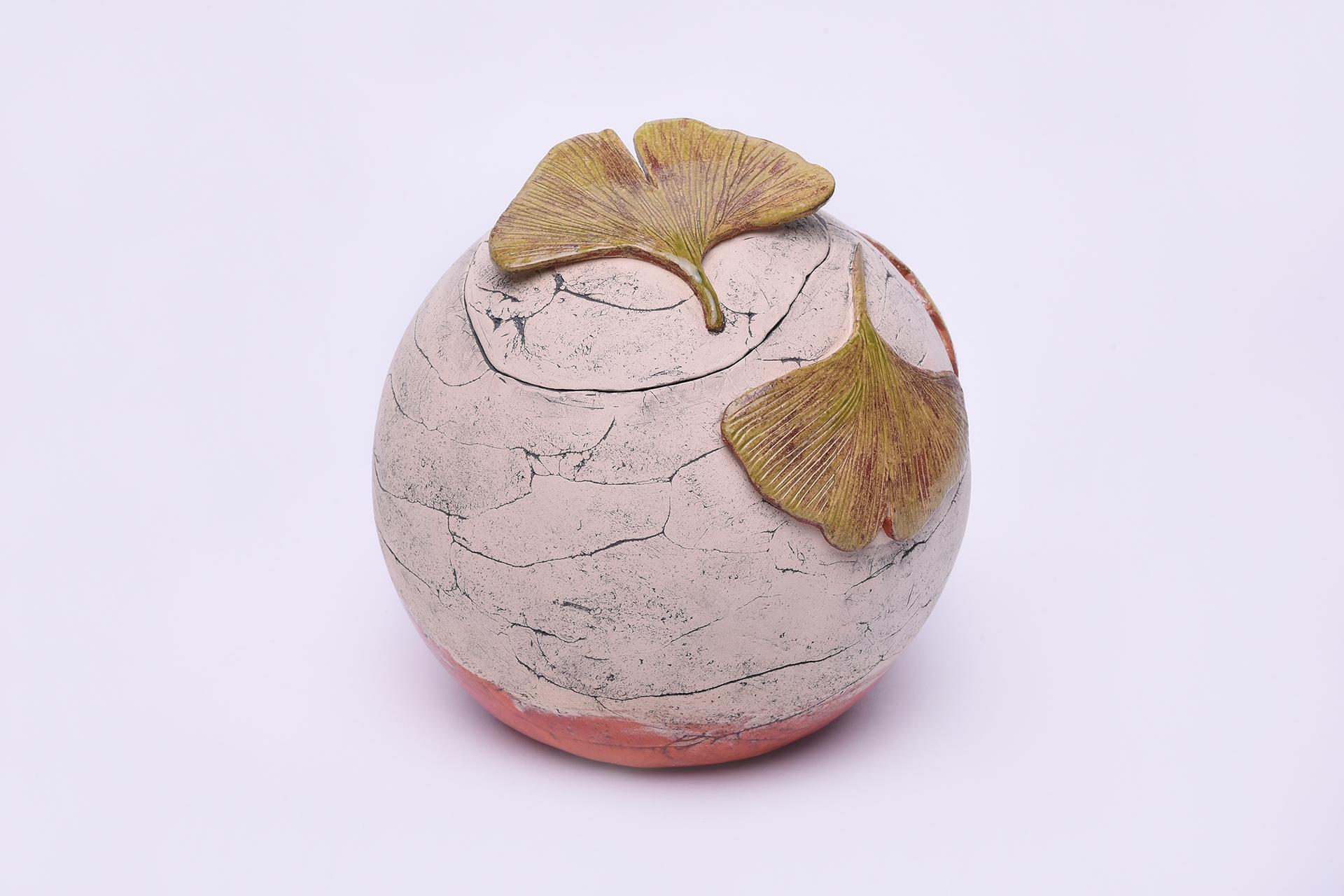 Round ceramic urn with ginkgo leaves by Heidi Hartmann