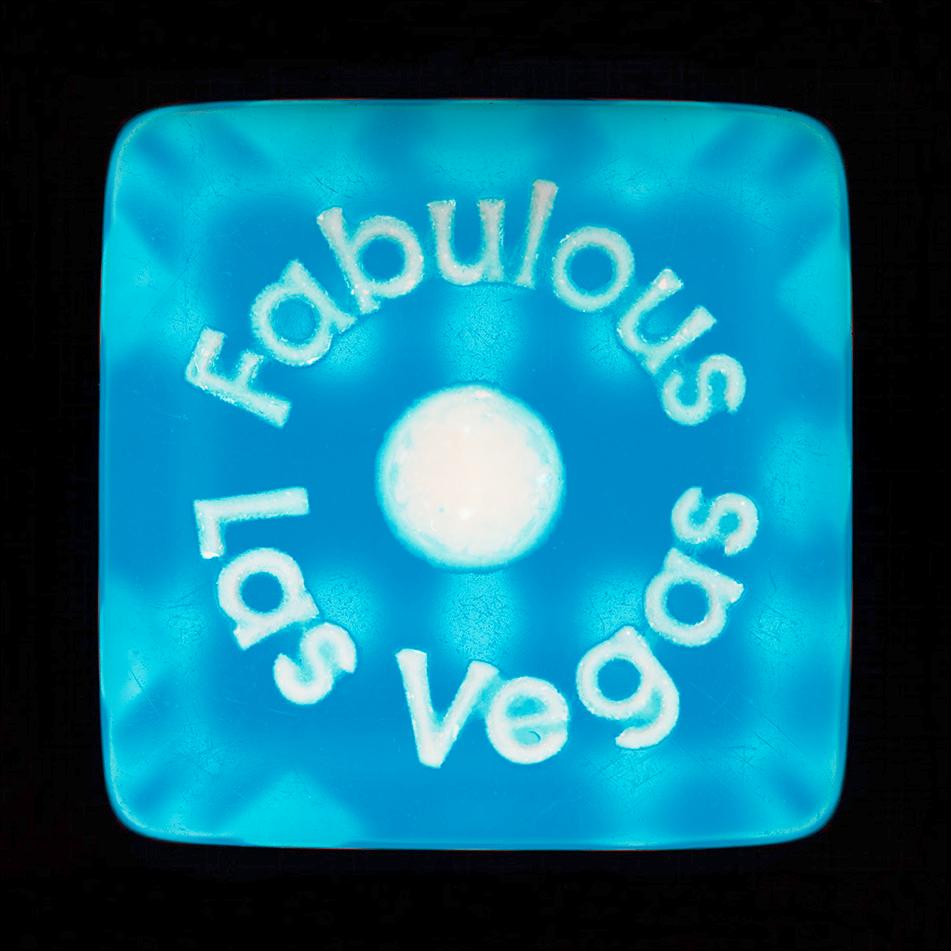 A blue Las Vegas dice suspended on a black background, hypnotically curious in both content and technique, viewers find themselves pleasantly puzzled. Heidler & Heeps have developed their own dichromatic technique resulting in something, which is