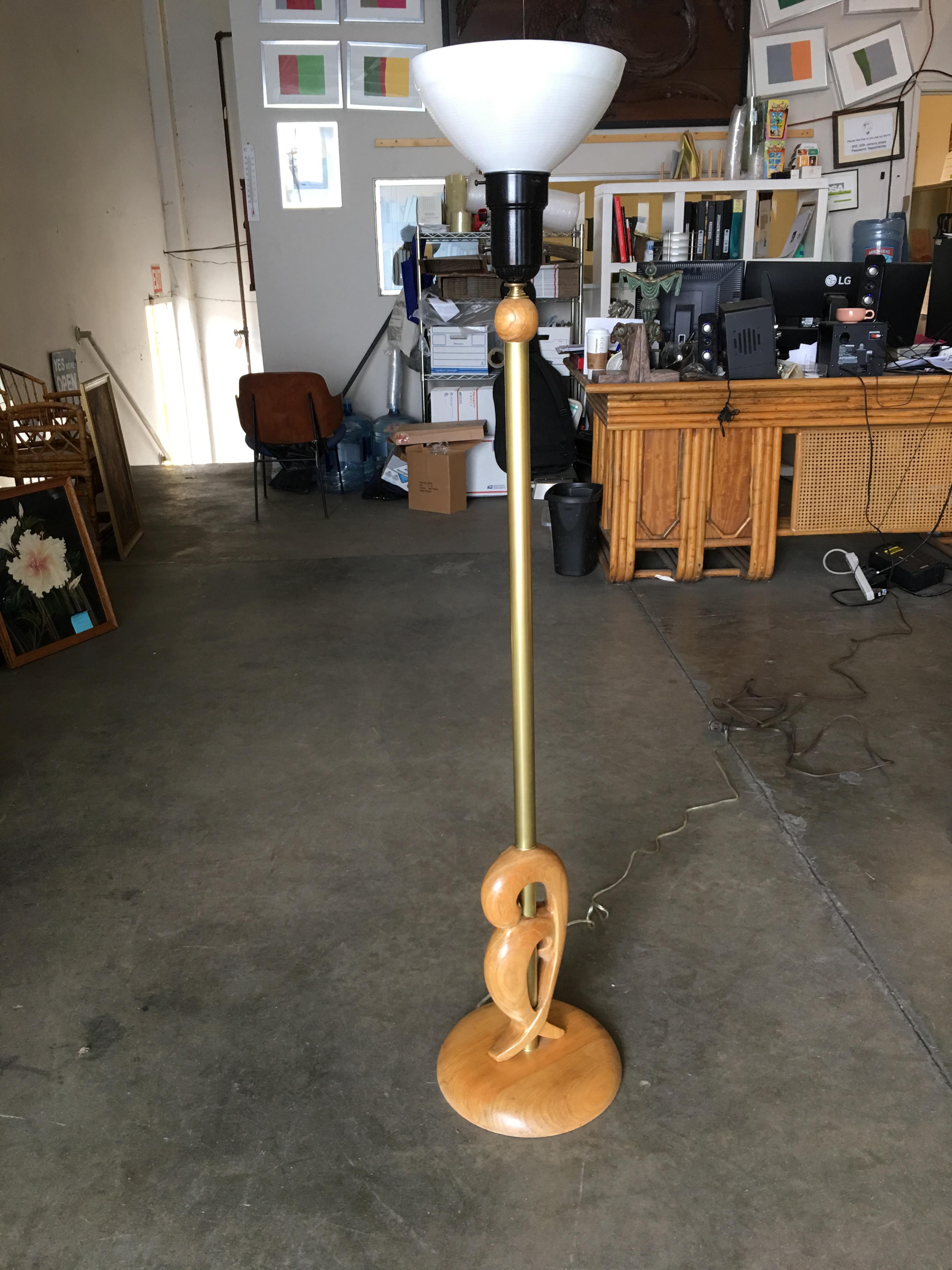 Heifetz style midcentury hand carved abstract wood torchiere floor lamp pair with milk glass shades and brass accents.