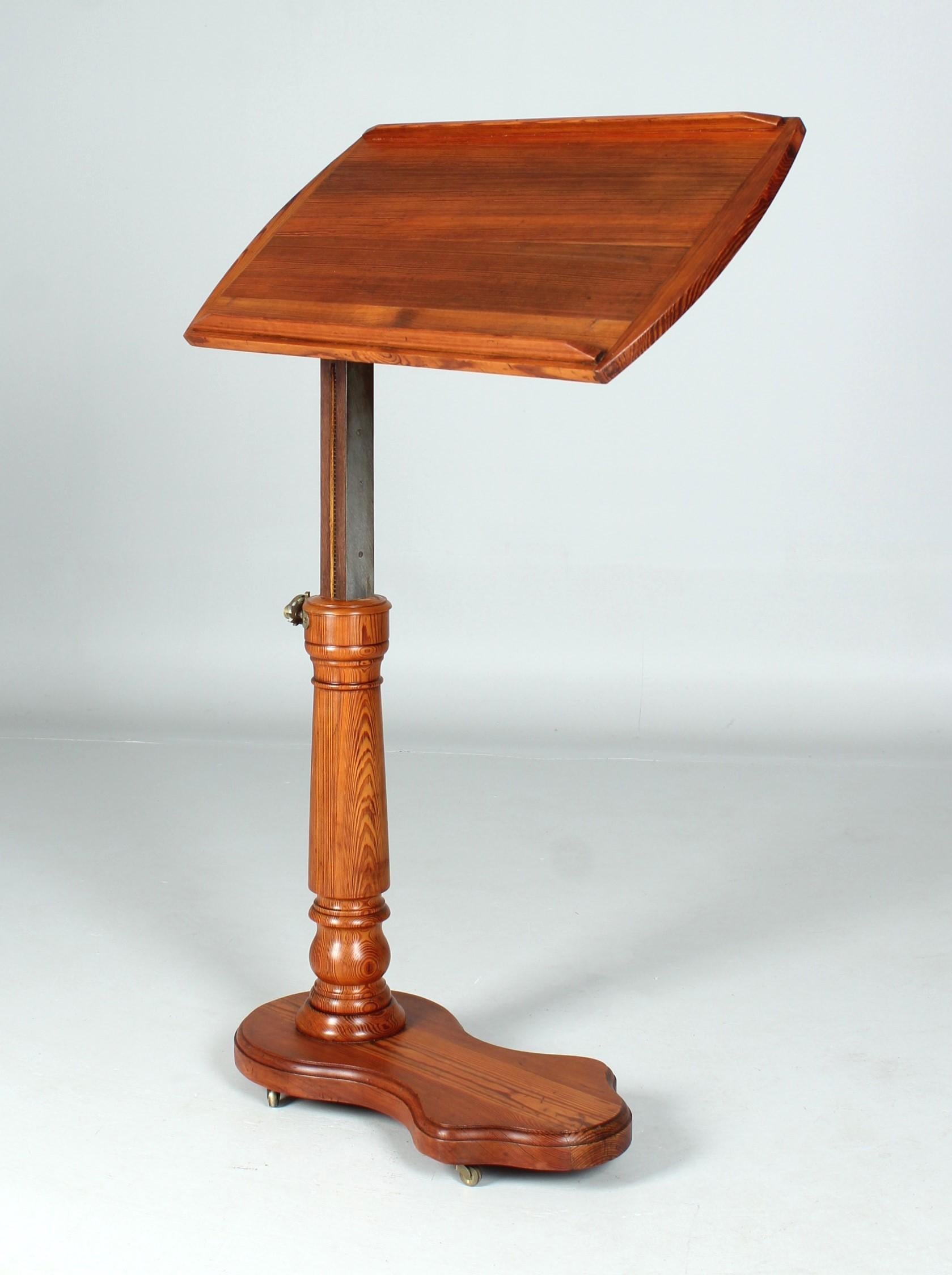 Antique height-adjustable reading table

France (Paris)
Pitch Pine
Late 19th century

Dimensions: height: 81-115 cm, width: 80 cm, depth: 40 cm

Description:
Reading table made of solid pine wood, adjustable in height and inclination.

The table top