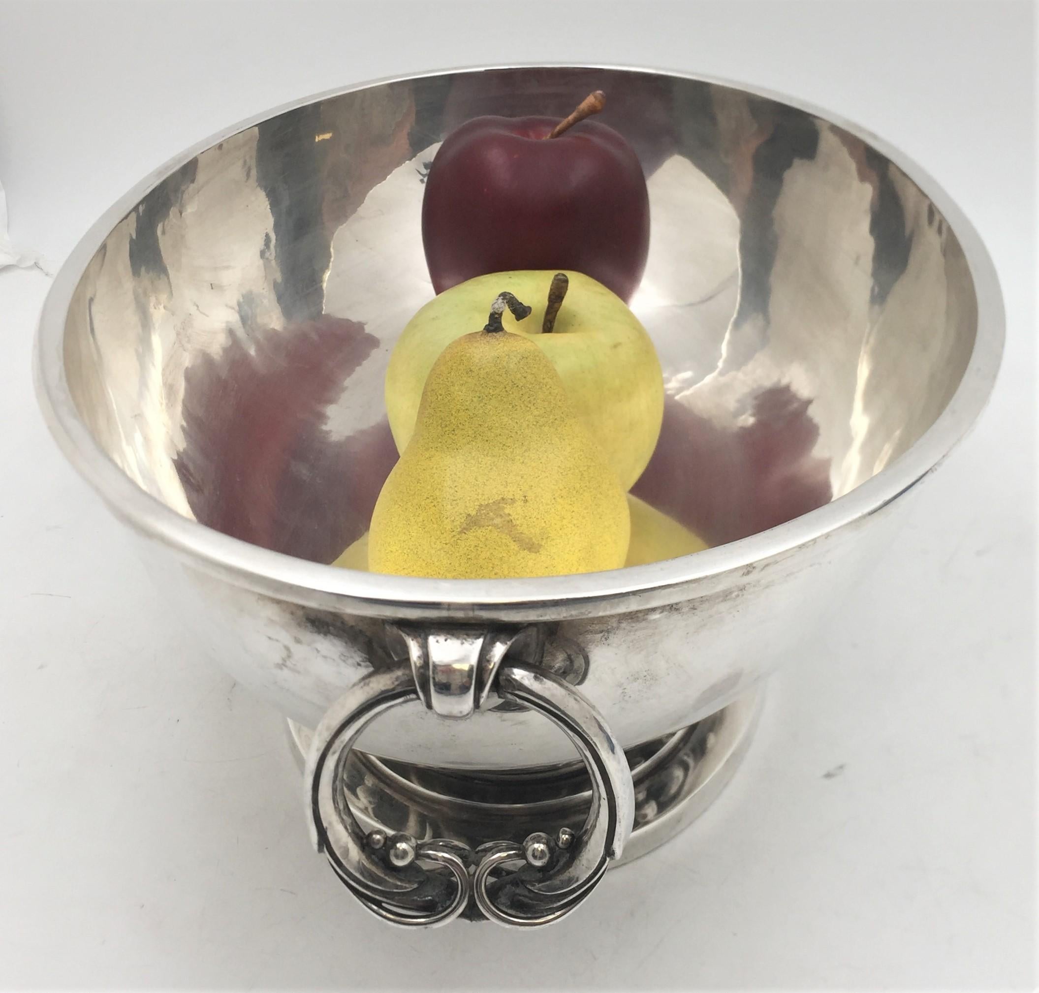 Heimburger, Danish silver, finely hand hammered centerpiece in Mid-Century Modern and Georg Jensen style, made between 1932 and 1960, designed with a stepped base and leaf scrolls on base with gradual sized beading, movable handles on each side with