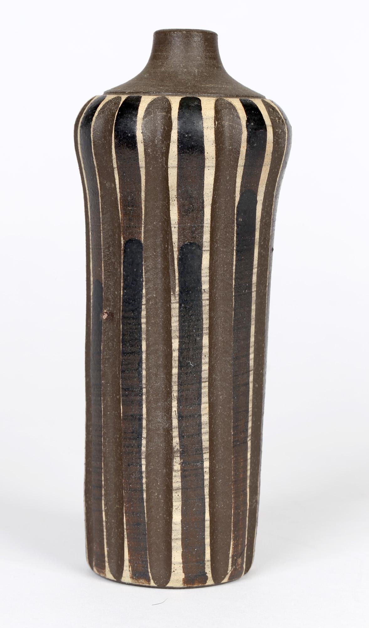 A very stylish German Bauhaus studio ceramic vase decorated in black and brown glazes by Heiner Hans Körting (1911-1991) and dating from 1940-50. The vase of tall cylindrical shape has a slightly rounded dome shaped top with a short narrow funnel