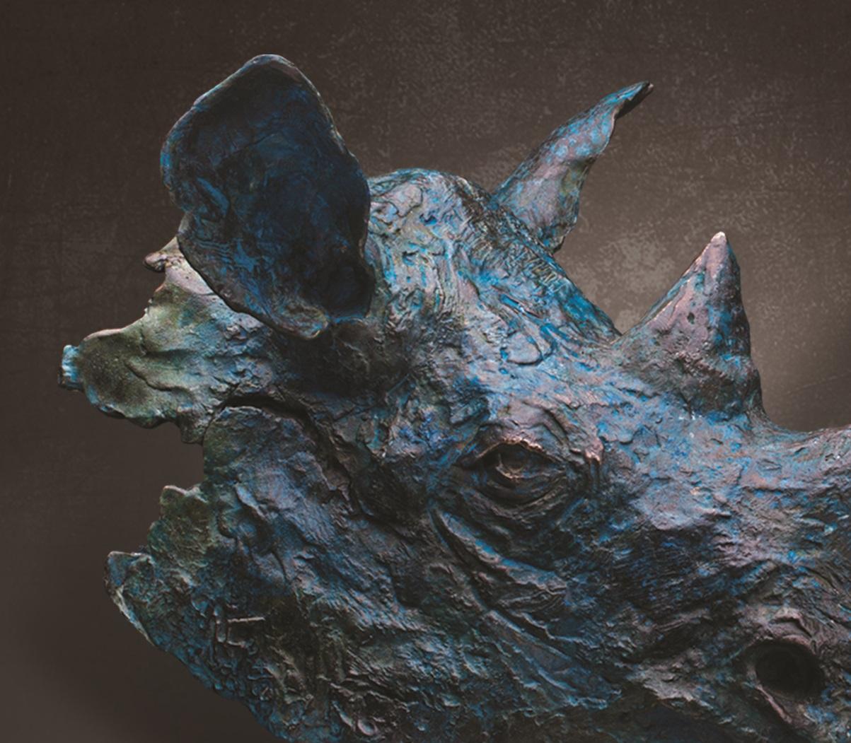 Black Rhino Bust in Bronze Blue Verdigris patina, Limited Edition of 12, bronze sculpture on Sandstone base. The first time I was sculpting in the field, all I saw oft this magnificent Black Rhino was its head sticking out from behind the bush. The