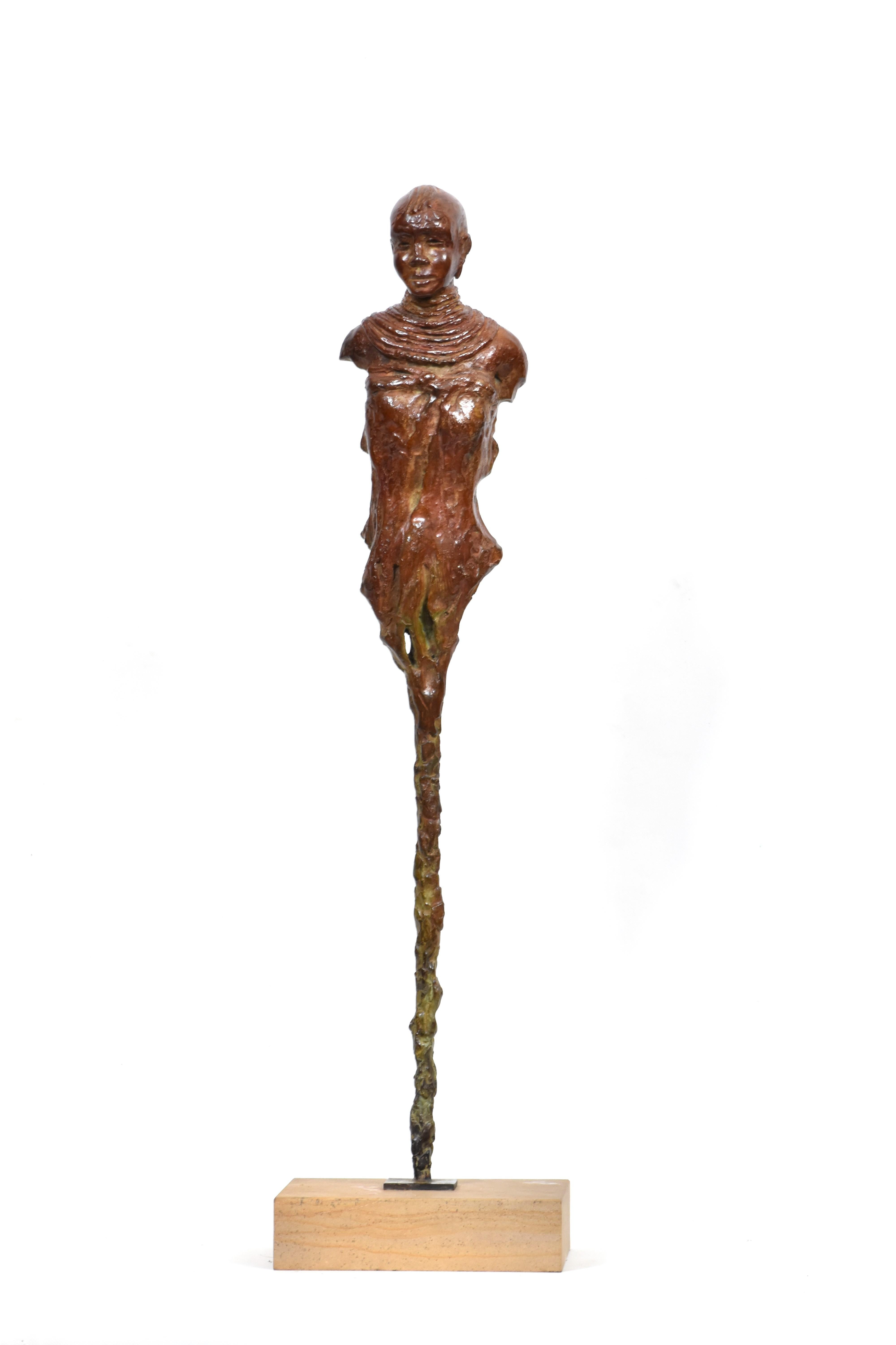 Bronze sculpture of young Turkana girl in traditional attire and characteristic hair style. The Turkana tribe, nomadic by nature, are a Nilotic people native to the Turkana District in northwest Kenya, a semi-arid climate region bordering Lake