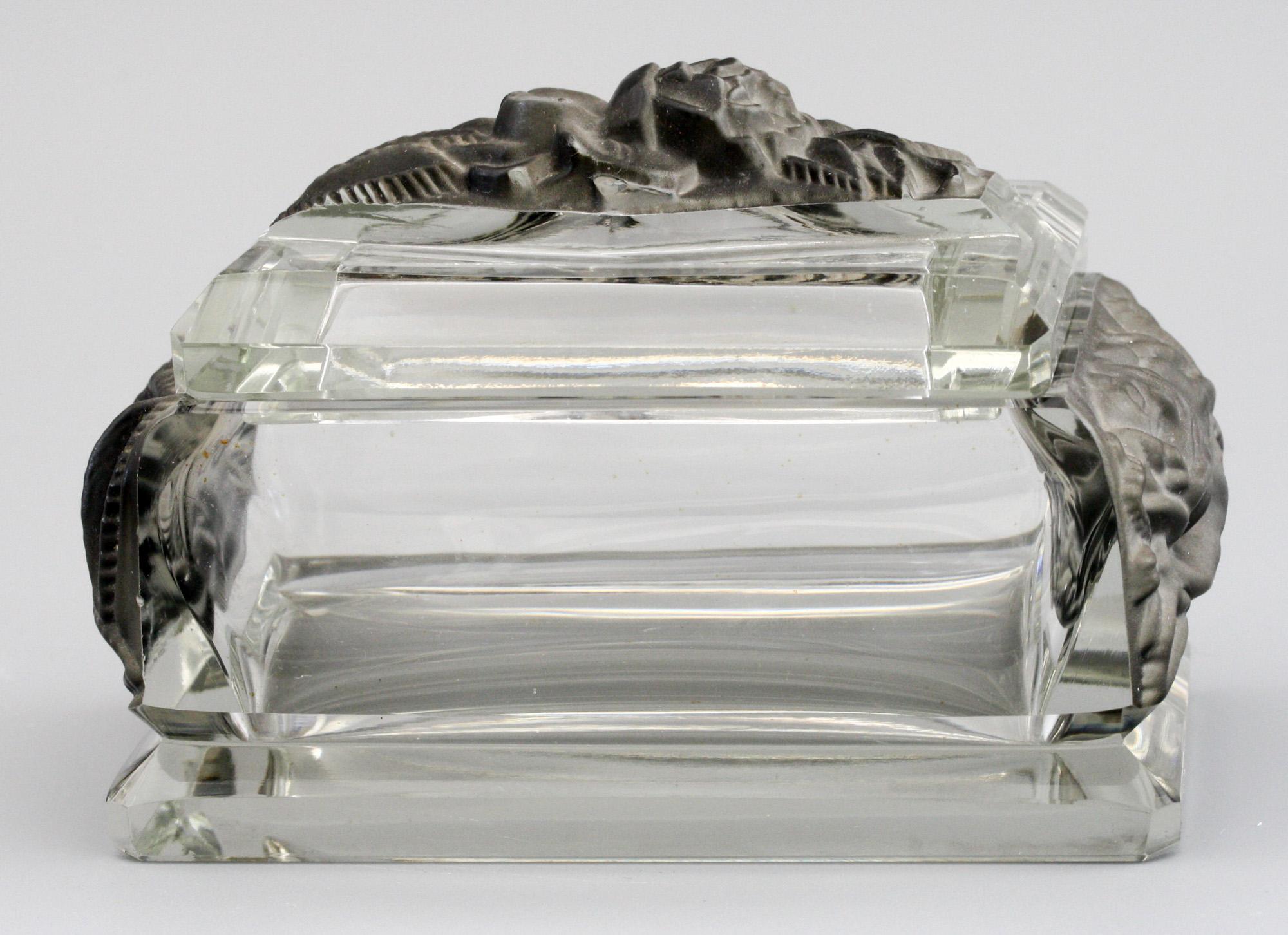 A very stylish Art Deco Czech lidded glass box relief molded with rose blooms attributed to Heinrich Hoffmann and dating from circa 1930. The rectangular shaped box has flat cut sides with an angle cut foot the end panels molded in high relief with