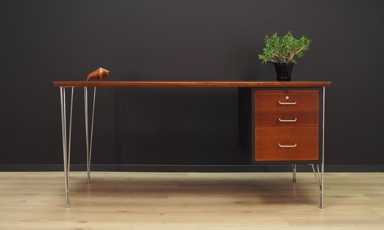 Exceptional desk from the 1960s-1970s, a minimalist form, designed by the renowned Danish designer Heinrich Roepstorff. Table top finished with teak veneer, legs made of chrome-plated metal. Desk has three drawers with compartments and a pull-out