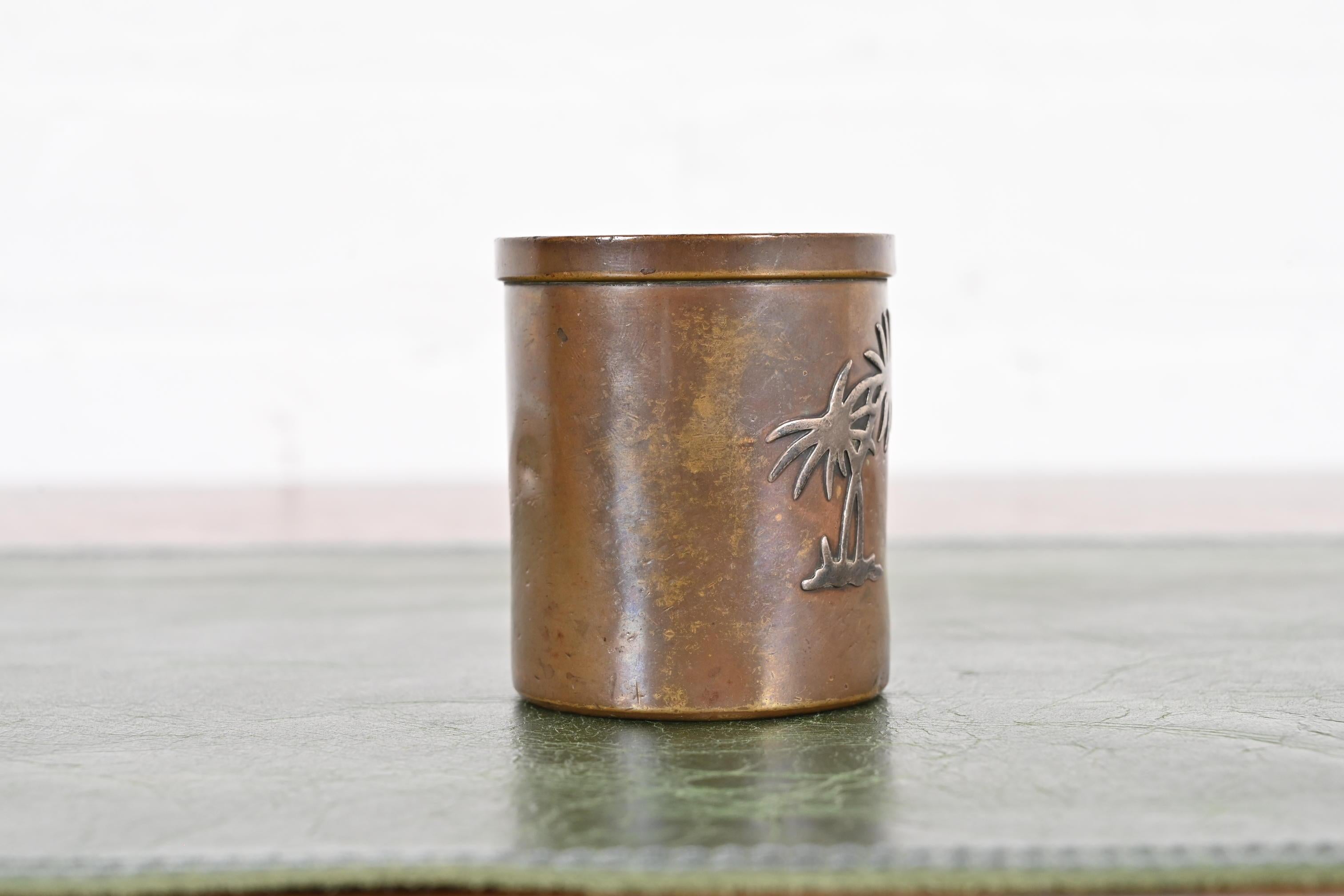 A gorgeous Art Deco or Arts & Crafts period sterling silver on bronze match cup or toothpick holder.

By Heintz Art Metal Shop

USA, Early 20th Century

Measures: 2.13