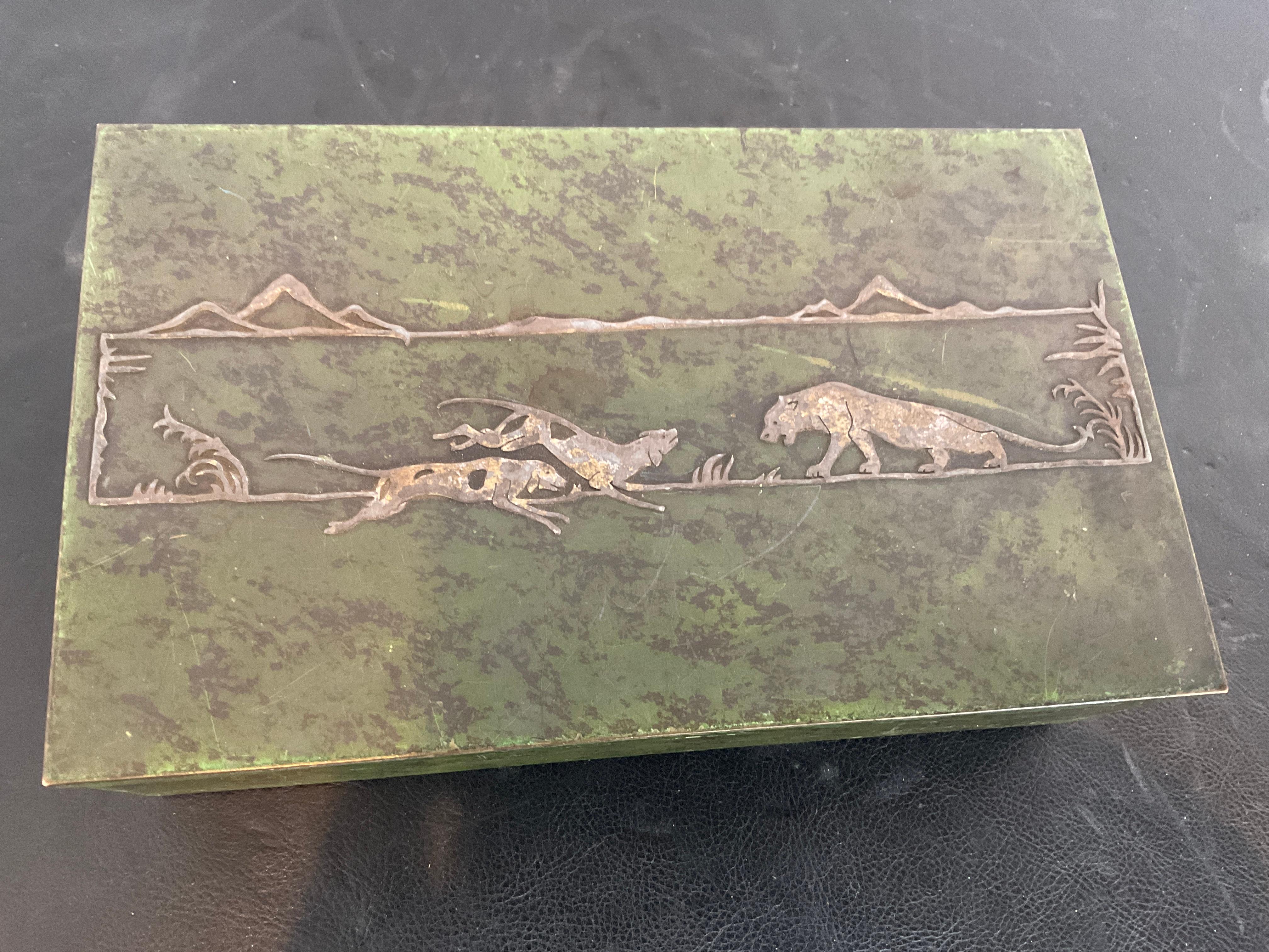 Sterling overlay on patinated bronze. Title of this piece is the hunt. Dogs hunting big cats.