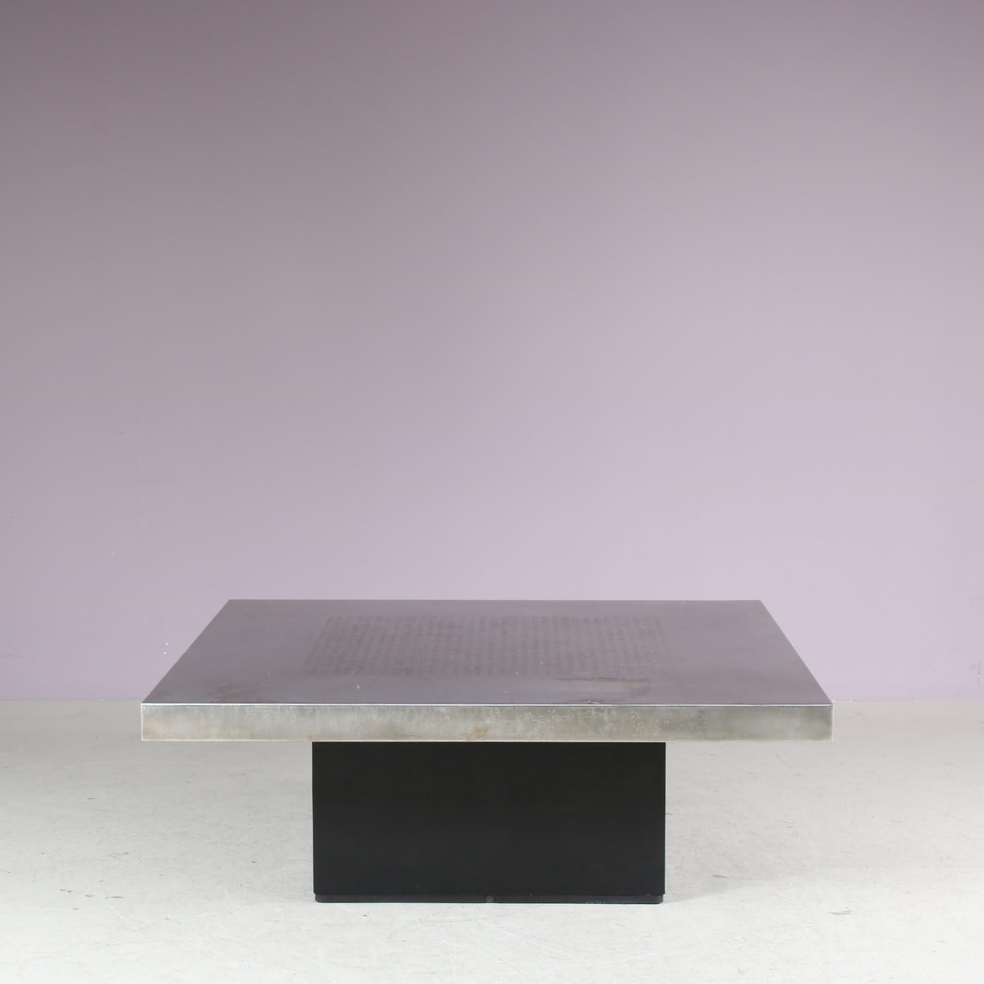 A beautiful square coffee table, designed by Heinz Lilienthal and manufactured in Germany around 1970.

This fantastic piece has a black wooden base with an etched metal top. The subtle yet detailed pattern in the top is a wonderful compliment to