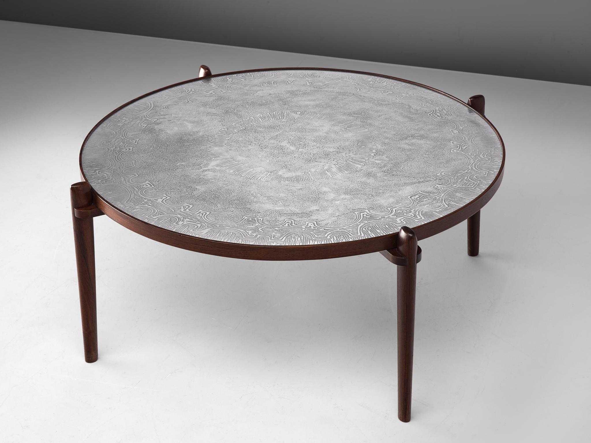 Heinz Lilienthal, coffee table, teak and steel, Germany, 1960s.

Circular coffee table designed by German Heinz Lilienthal. The elegant patterned etched tabletop is executed in steel, inlayed in a wooden edged base. The legs placed outside the