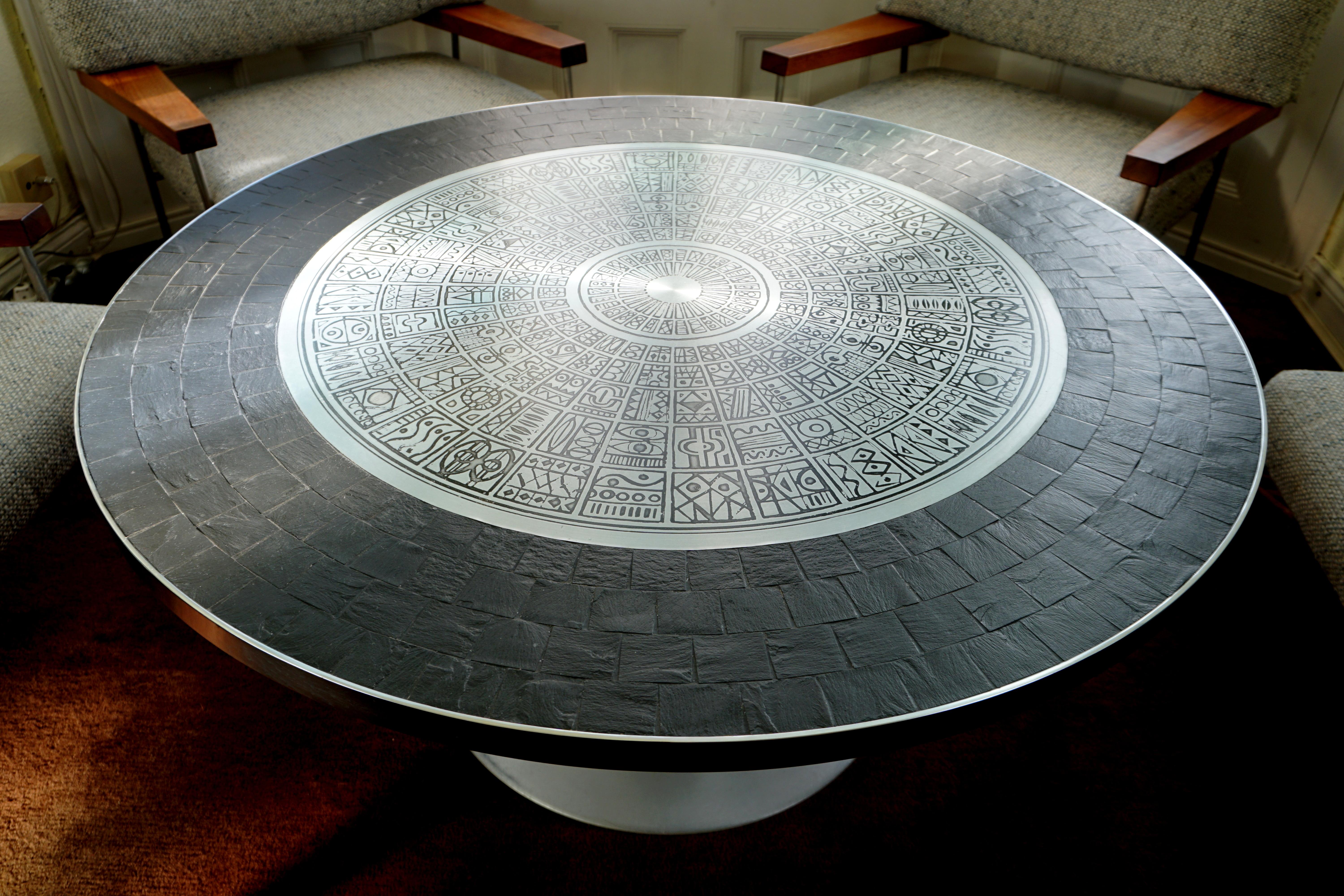 Important and very rare coffee table by German Sculptor Heinz Lilienthal, 1927-2006.
The etched stainless- steel-plate of the tabletop with the archaic but timeless pattern is exemplary for the talent of this Artist.
Stainless steel and Slate