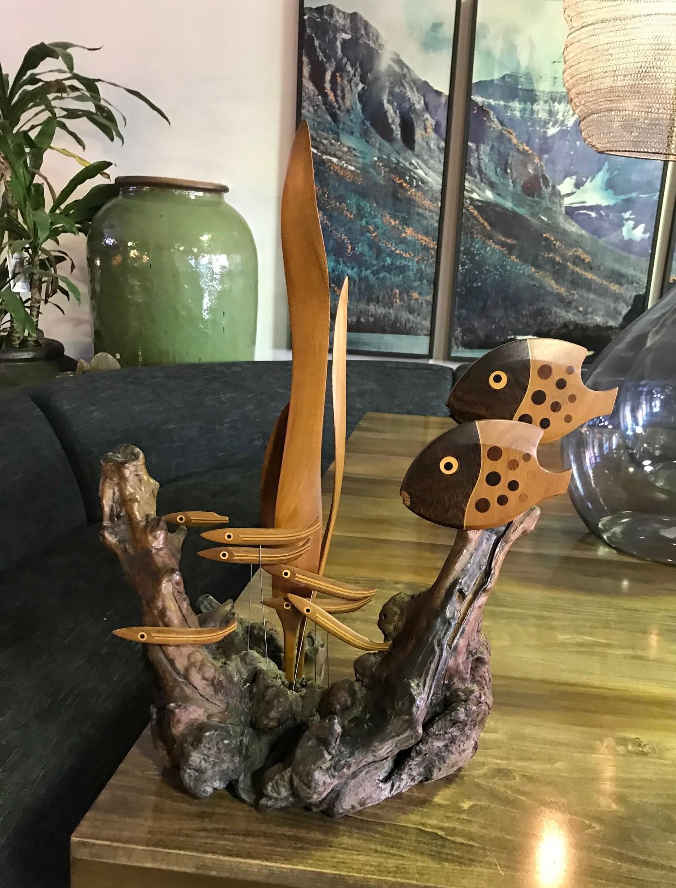 A rather wonderful and whimsical work by wood sculptor/artist Heinz Norhausen. 

Made from a solid, organic wood base. The sculpture features underwater plants, various fish and marine life in an aquatic scene. Quite inventive.

Signed and