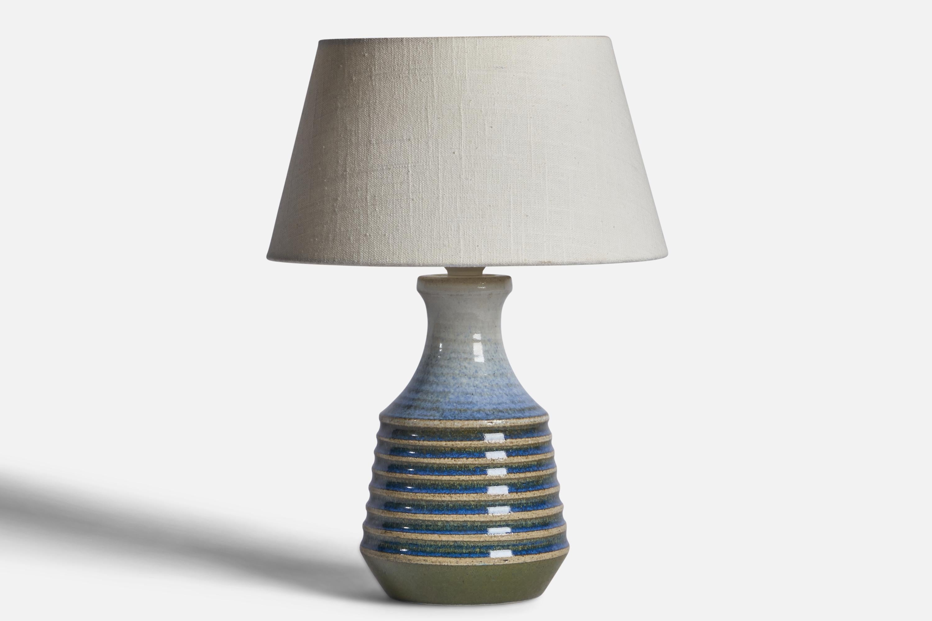 A unique blue and green-glazed stoneware table lamp designed by Heinz Schlichting and produced by Ego Stengods, Sweden, c. 1960s.

Dimensions of Lamp (inches): 11” H x 5.25” Diameter
Dimensions of Shade (inches): 7” Top Diameter x 10” Bottom