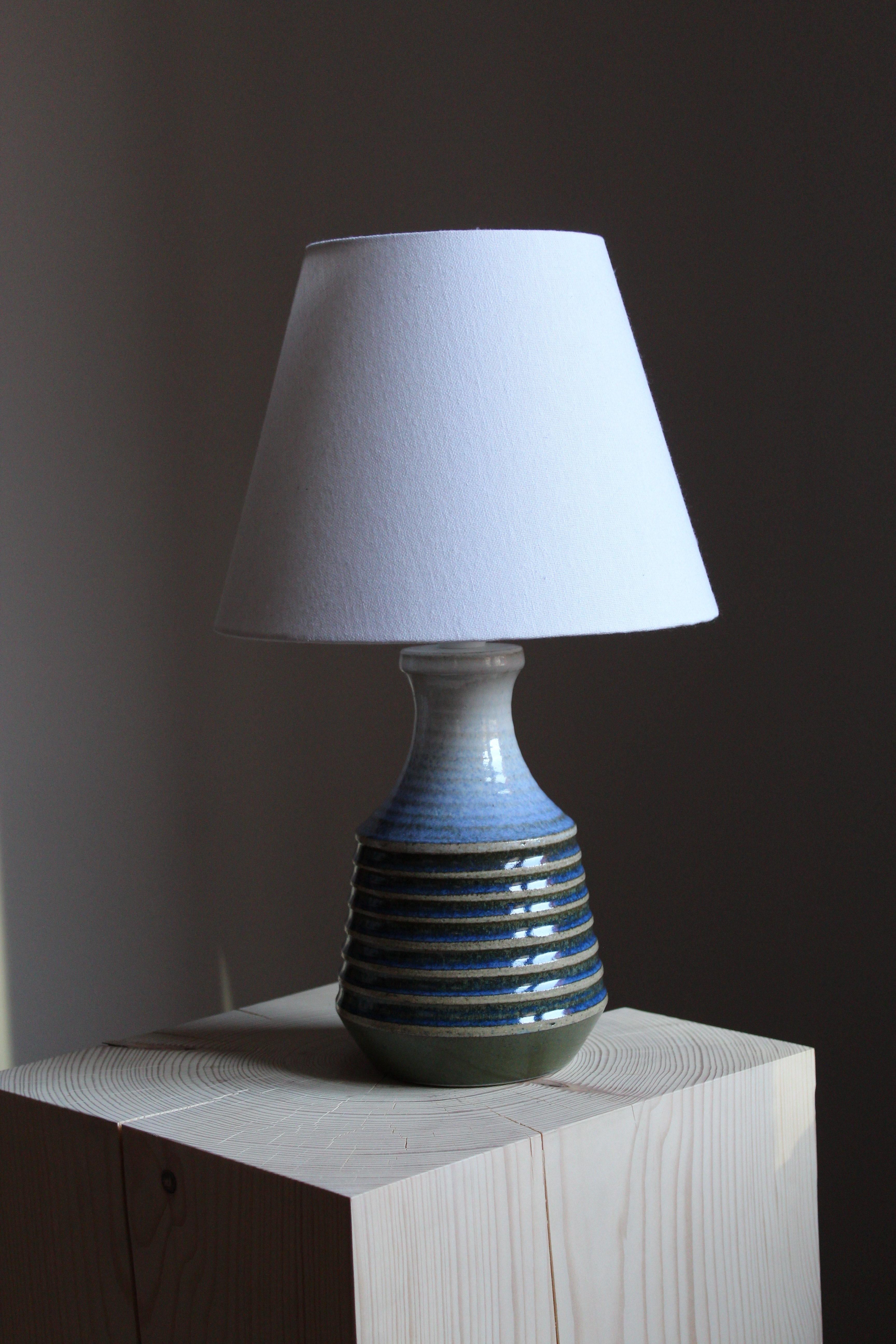 A stoneware table lamp, designed by Heinz Schlichting. Produced by Studio Ego, Sweden, 1960s. Signed

Lampshade in images is not included. Dimensions stated excluding lampshade.

Glaze features blue-grey-black colors.

Other ceramicists of the