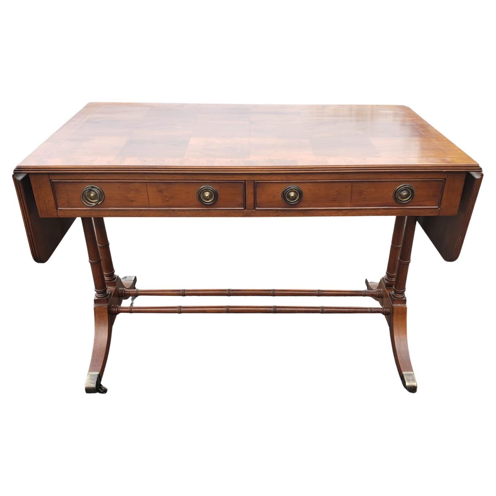 Very original and exquisite Hekman drop-leaf marquetry book matched 2-drawer writing desk. Original wheels, with 2 dovetailed drawers. Faux bamboo trestle and pedestals.
Measures 41