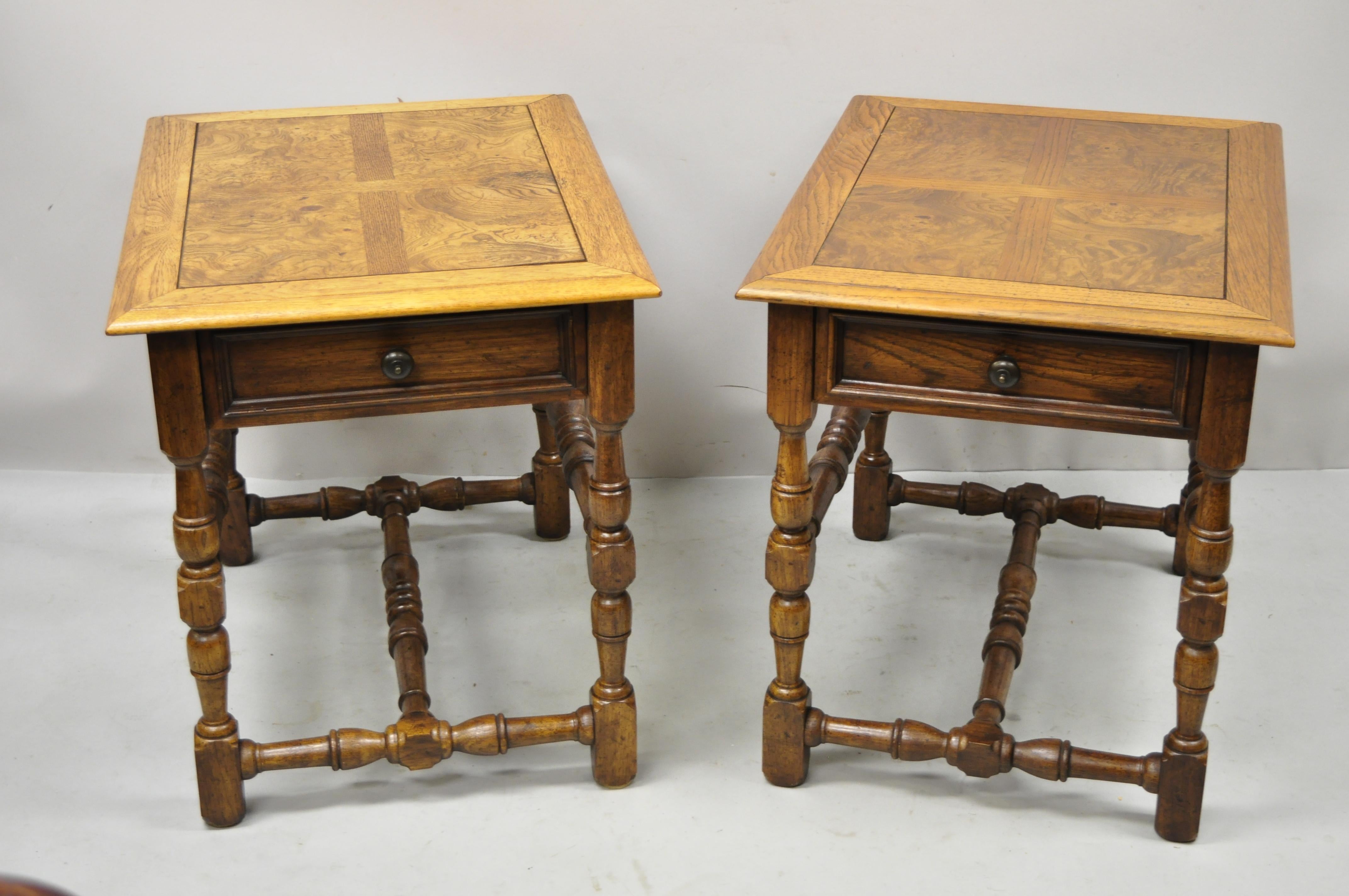 Hekman French Country English Jacobean oak burlwood lamp end tables - a pair. Item features turn carved legs and stretchers, beautiful wood grain, original stamp, 1 dovetailed drawer, very nice vintage item, quality American craftsmanship, great
