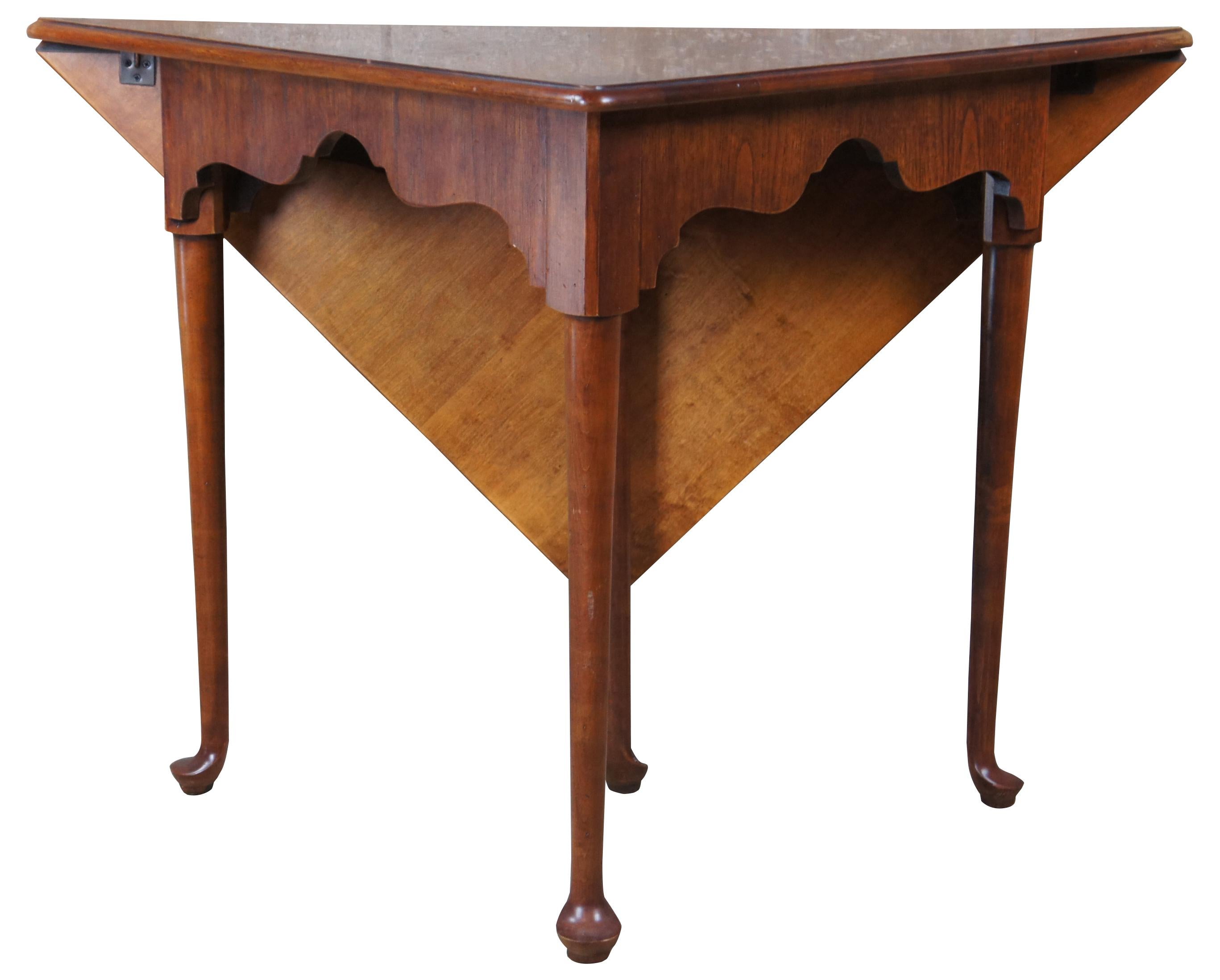 Handkerchief table by Hekman Furniture Co, 5-2015, circa 1980s . Drawing inspiration from Colonial Williamsburg and Queen Anne styling. Features a triangular top of olive ash burl over carved aprons and long tapered legs leading to pad feet. Back