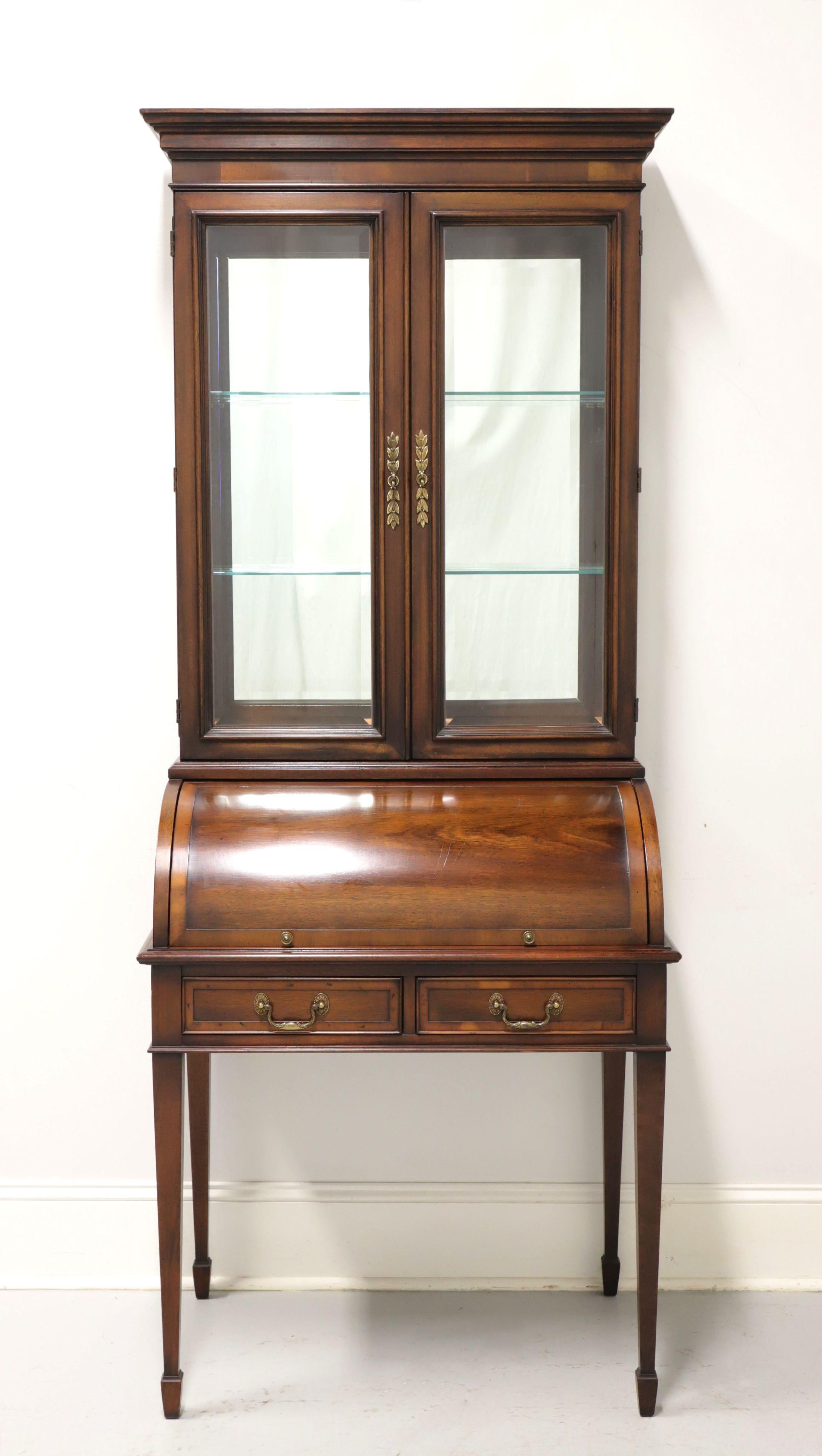 A Traditional style petite secretary desk by Hekman. Solid mahogany with yew wood banding, brass hardware, crown moulding at top, tapered straight legs, and spade feet. Upper cabinet has beveled glass doors & side panels, is lighted, mirrored back,