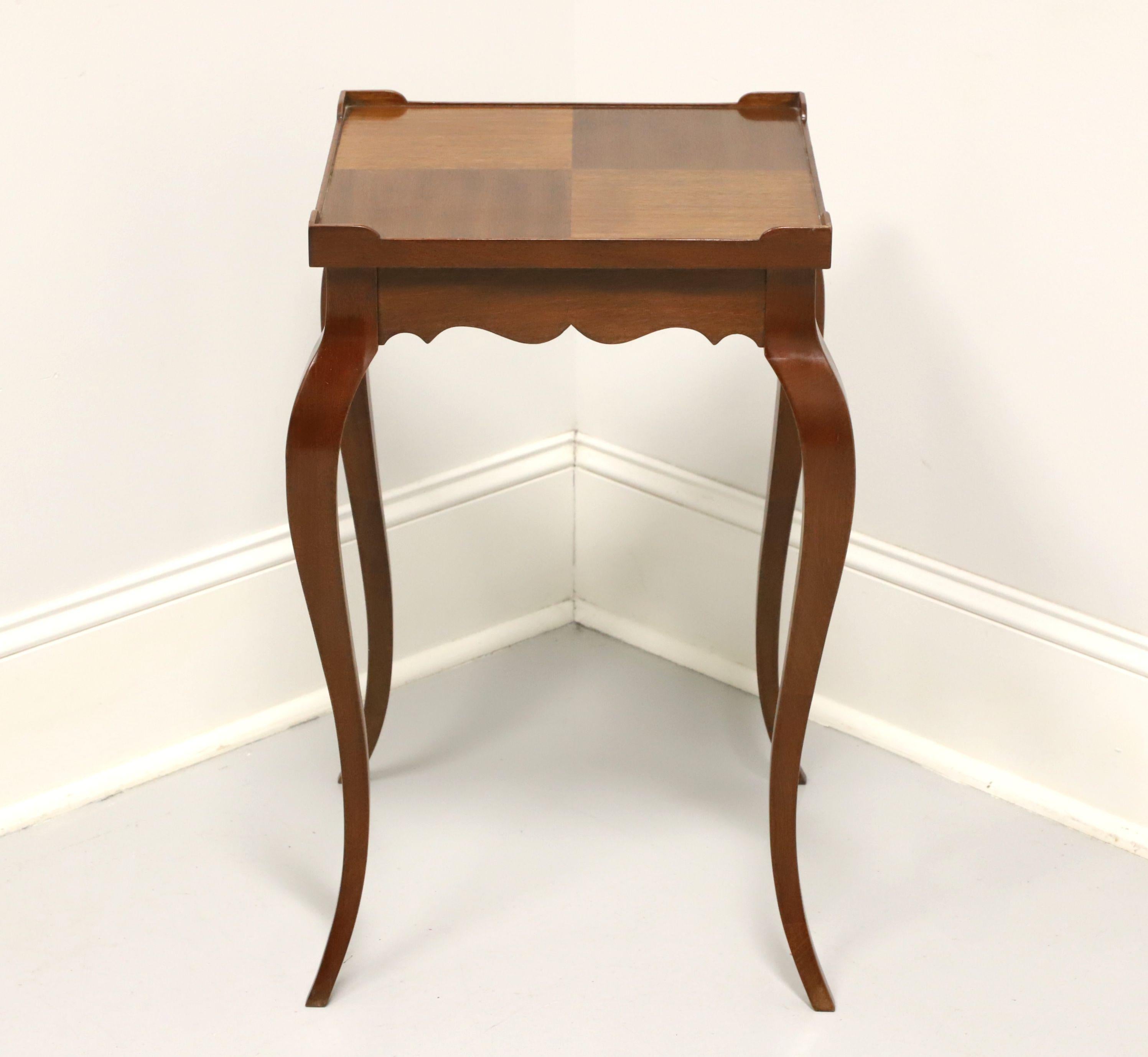 A French Louis XV style side table by Hekman Furniture, of Lexington, North Carolina, USA. Walnut with inlaid parquetry to top, carved apron and cabriole legs. Features the inlaid parquetry top with raised corners forming a partial gallery. Made in