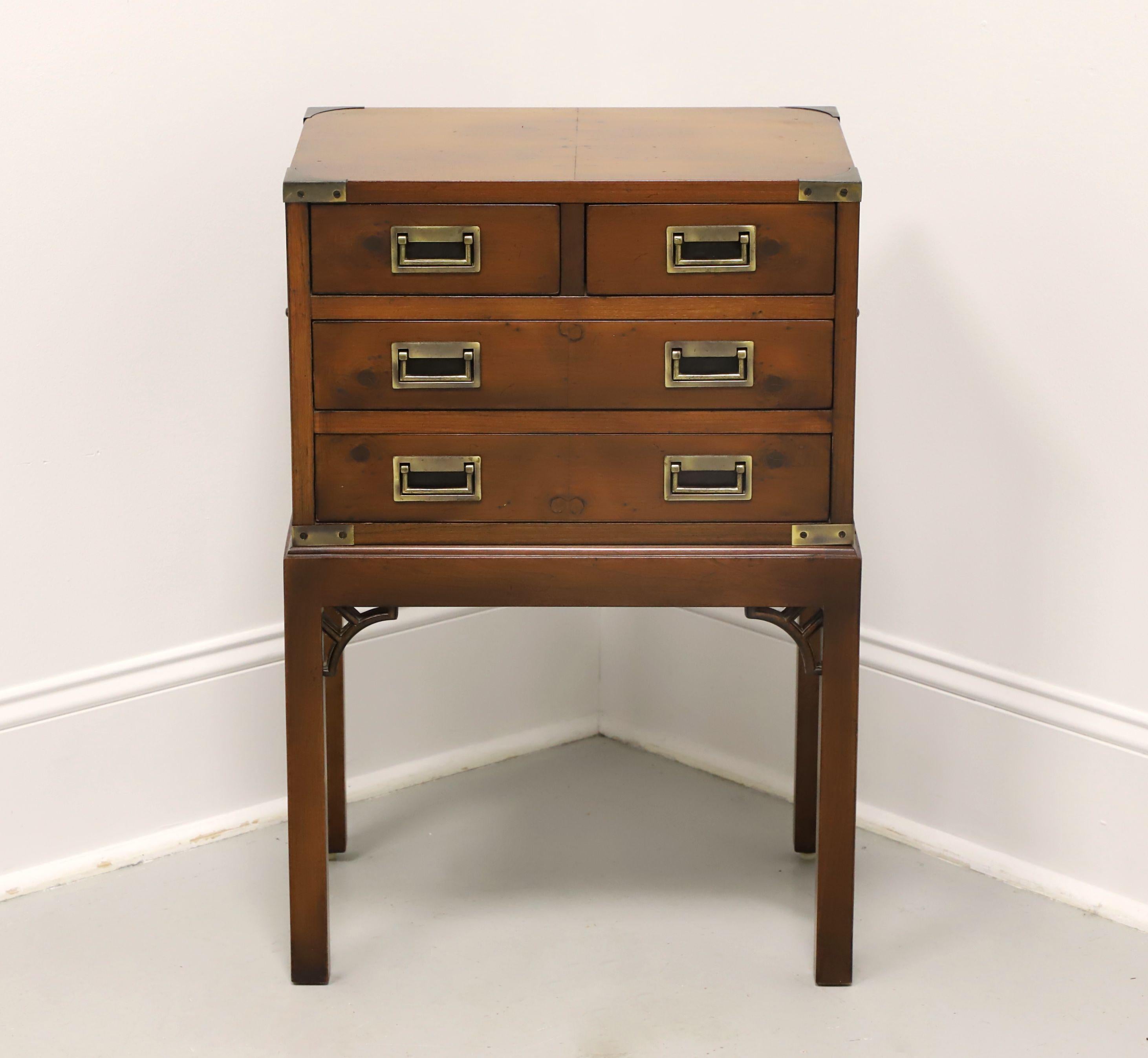 A Campaign style silver chest by Hekman Furniture. Yew wood with brass accents & hardware, fixed chest on stand design, brass side handles, fretwork at leg joints, and square straight legs. Features two smaller over two larger drawers of dovetail