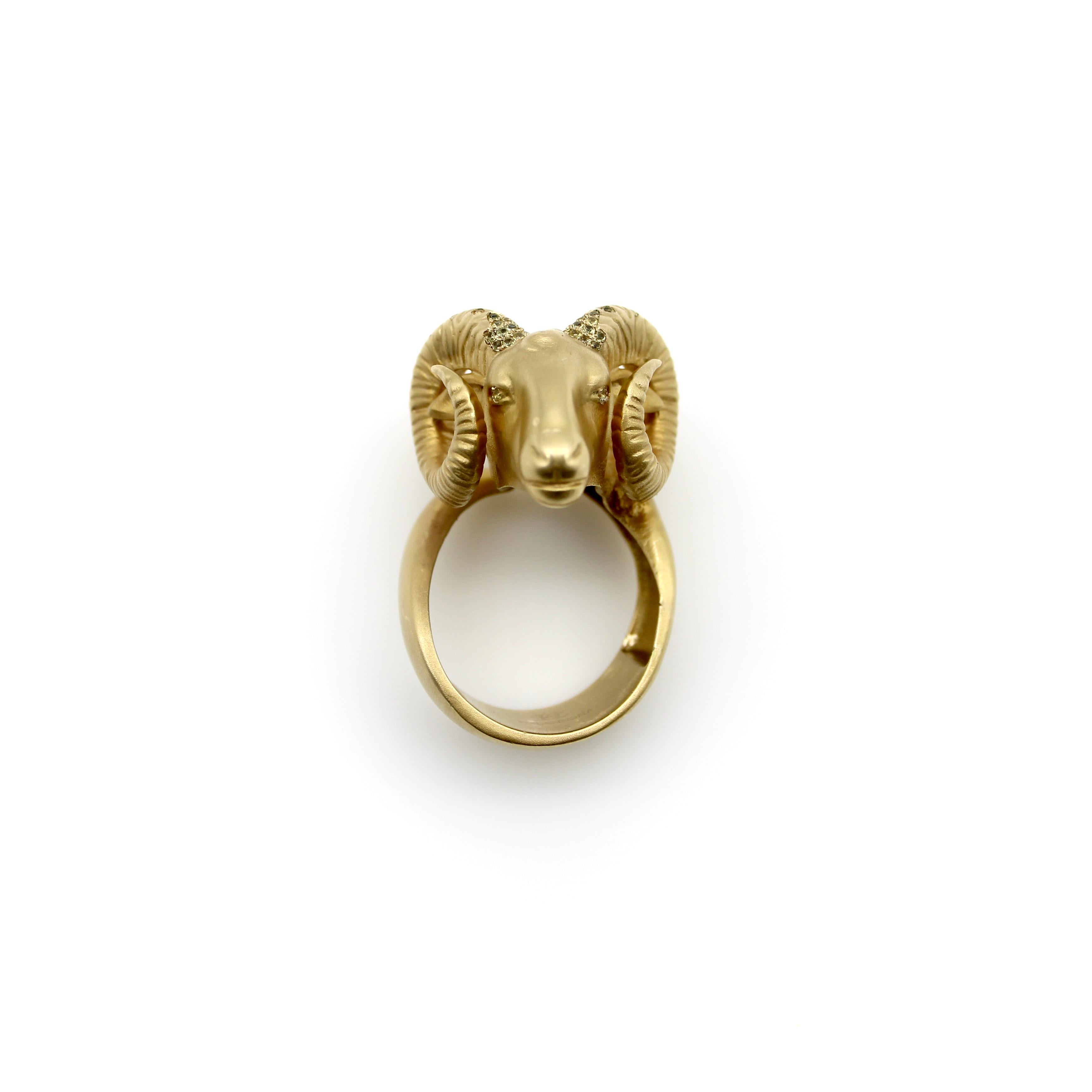 Designed by Helannona, this 14k gold ram ring has a powerful presence on the hand. The ring consists of the head of a mature ram, with a full set of horns that make a spiral around both sides of the ram’s face, while the body of the animal creates a