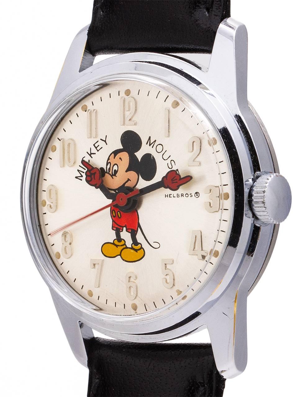 
Vintage medium size Helbros 17 jewel manual wind Mickey Mouse watch circa 1970’s. Featuring 30mm diameter base metal case with steel snap down back, with acrylic crystal, and with excellent condition original dial with polychrome depiction of