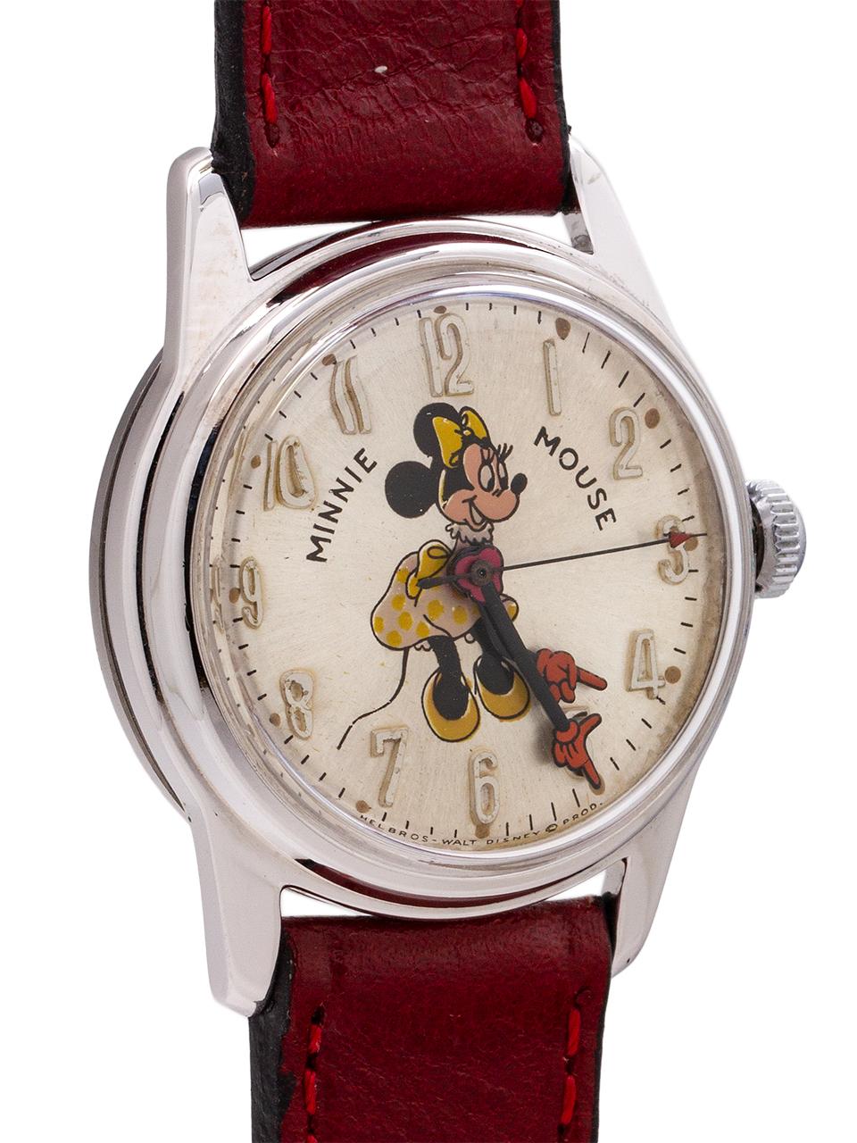 Vintage Helbros 17 jewel manual wind Minnie Mouse watch circa 1970’s. Featuring 31mm diameter chromium plated base metal case with steel snap down back. With acrylic crystal, and excellent condition original dial with polychrome depiction of popular