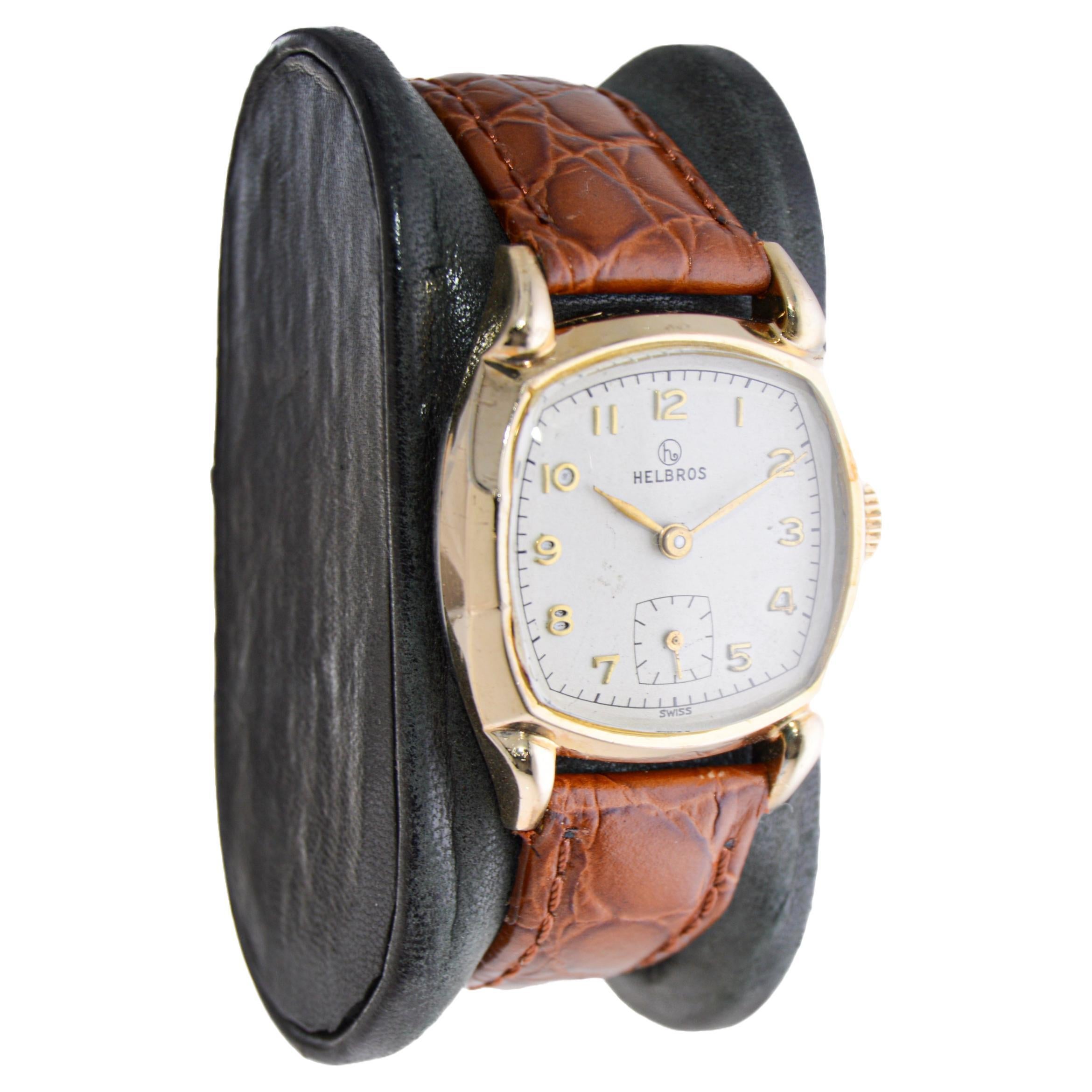 FACTORY / HOUSE: Helbros Watch Company
STYLE / REFERENCE: Art Deco / Cushion Shape
METAL / MATERIAL: Yellow Gold-Filled
CIRCA / YEAR: 1940's
DIMENSIONS / SIZE: 37mm Length X 29mm Diameter
MOVEMENT / CALIBER: Manual Winding / 17 Jewels / Caliber